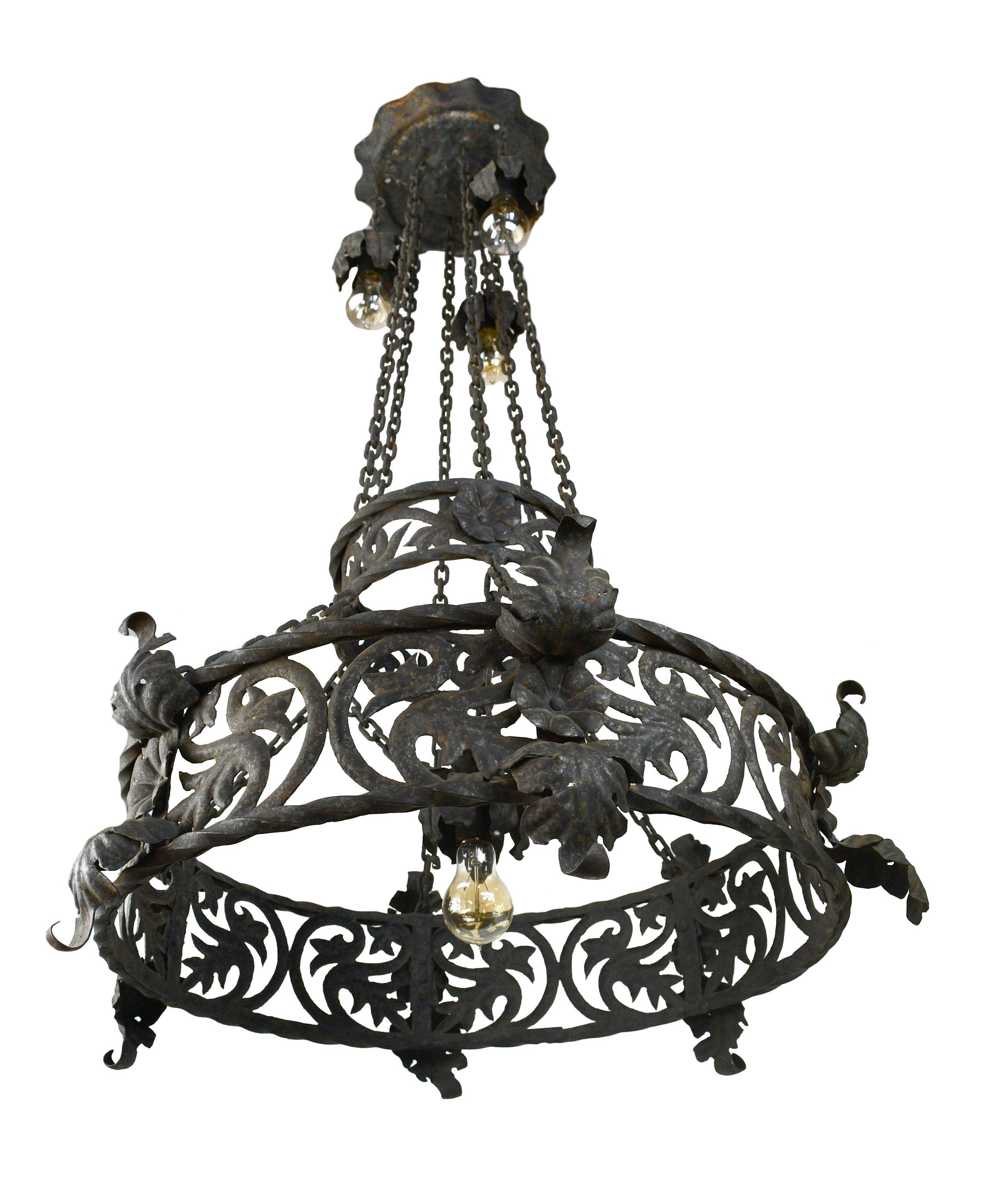 This chandelier is incredible because of the dedication to simple details. Every piece of iron on this chandelier has been uniquely formed, no piece of metal is flat. Twisted iron rings provide structure to the curved ornamentation of flowers and