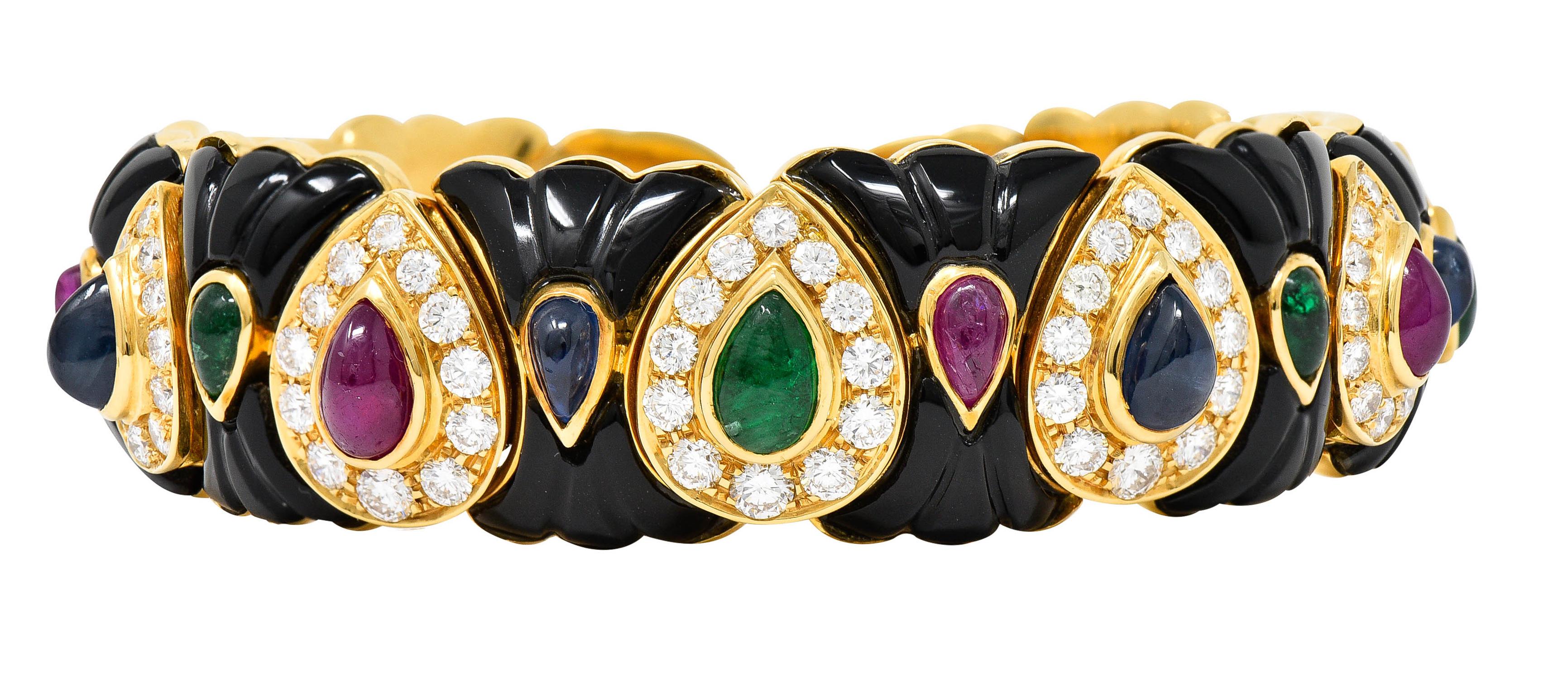 Cuff bracelet is comprised of hour glass shaped links alternating with chestnut shaped links

Hourglass links feature calibrè cut onyx - opaque black with excellent polish

Chestnut shaped links are bead set with halos of round brilliant cut
