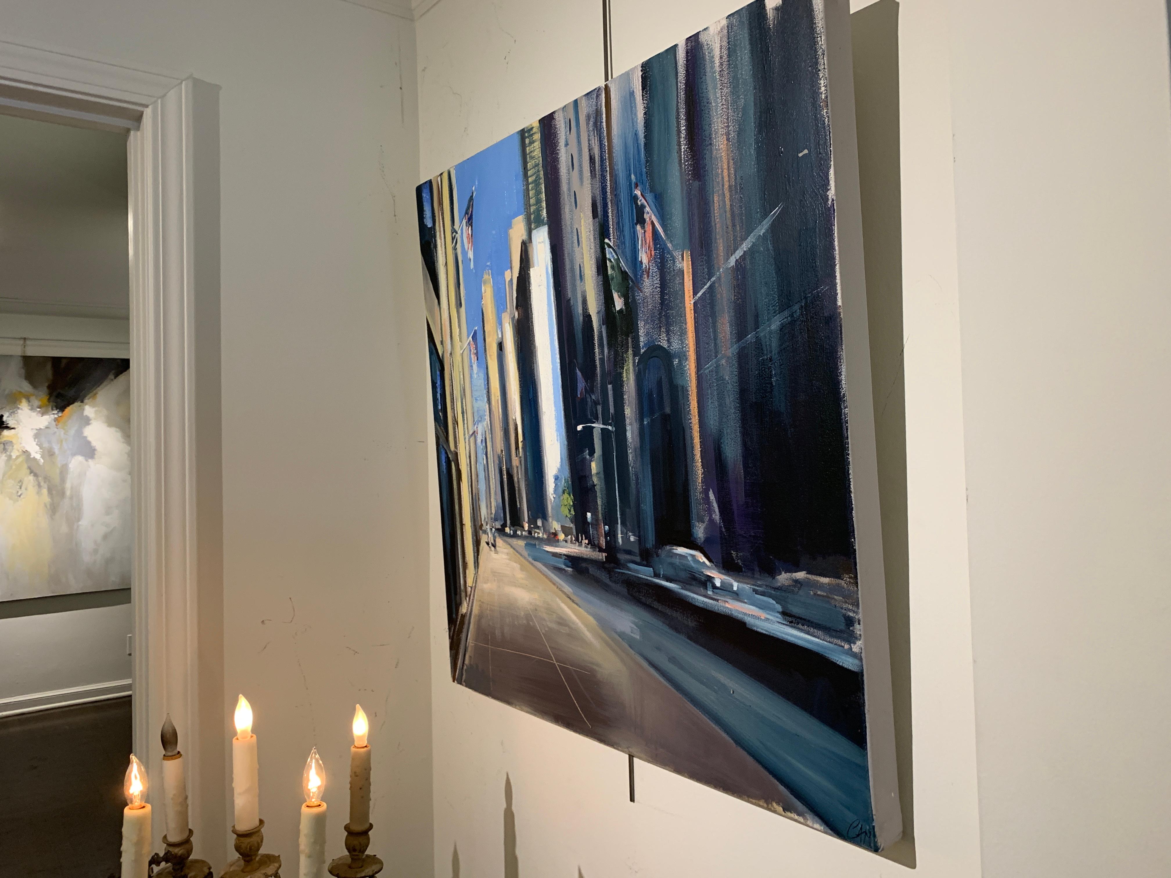 'City Avenue' is a representational oil on canvas cityscape painting created by American artist Craig Mooney in 2019. Featuring an exquisite palette mostly made of blue and cream tones, accented with touches of purple, the painting depicts a