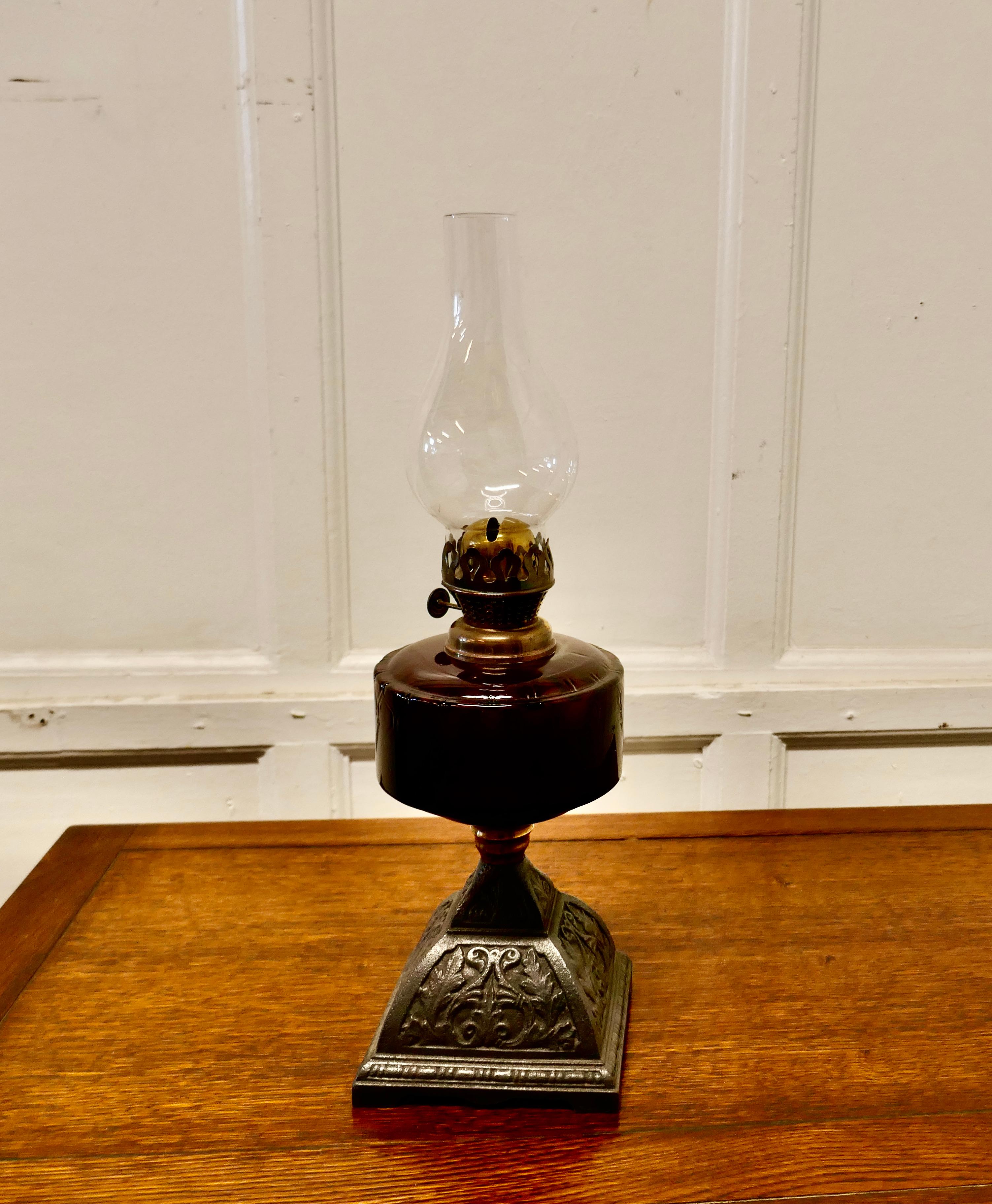 Cranberry glass oil lamp on decorative iron base

A beautiful glass iron lamp set on an Iron base, the lamp is a great looking piece, it has a glass chimney and a burner but I cannot guarantee if it is in working condition 


The lamp is in