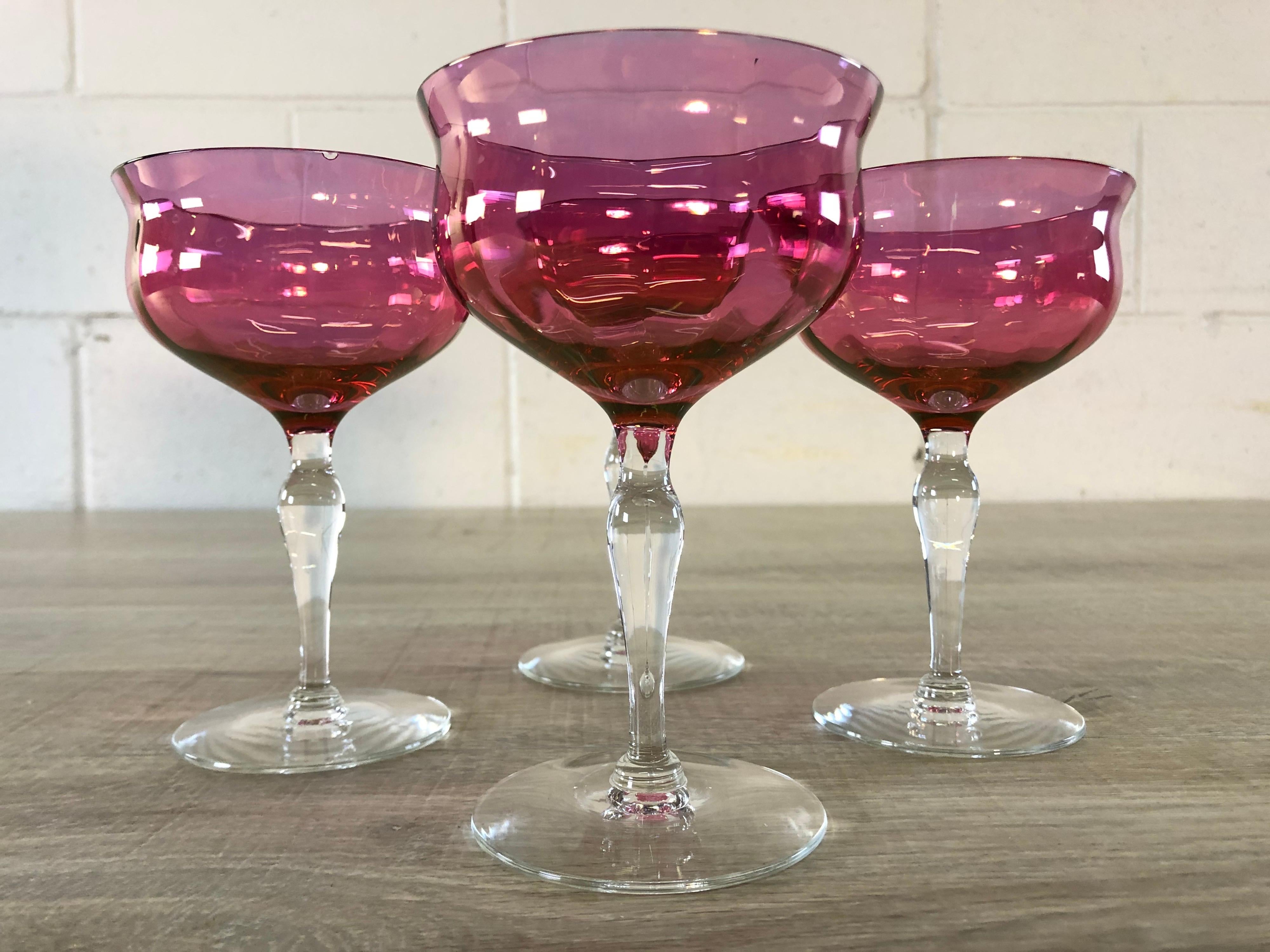 Vintage set of four cranberry iridescent glass coupe stems. No marks.