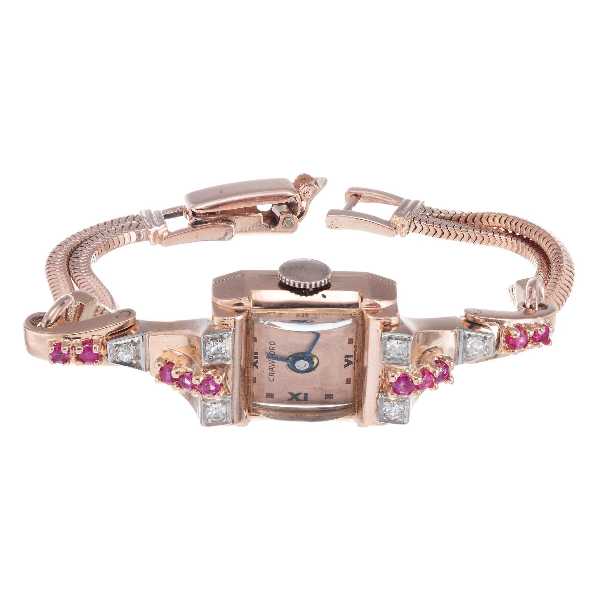 Vintage retro 1940’s Crawford 14k rose gold ruby and diamond wristwatch with rose gold double snake chain bracelet. 6.75 inches

6 round diamonds, approx. .12cts
10 genuine rubies, approx. .20cts
14k rose gold 
Length: 38.07mm
Width: 14.97mm
Case