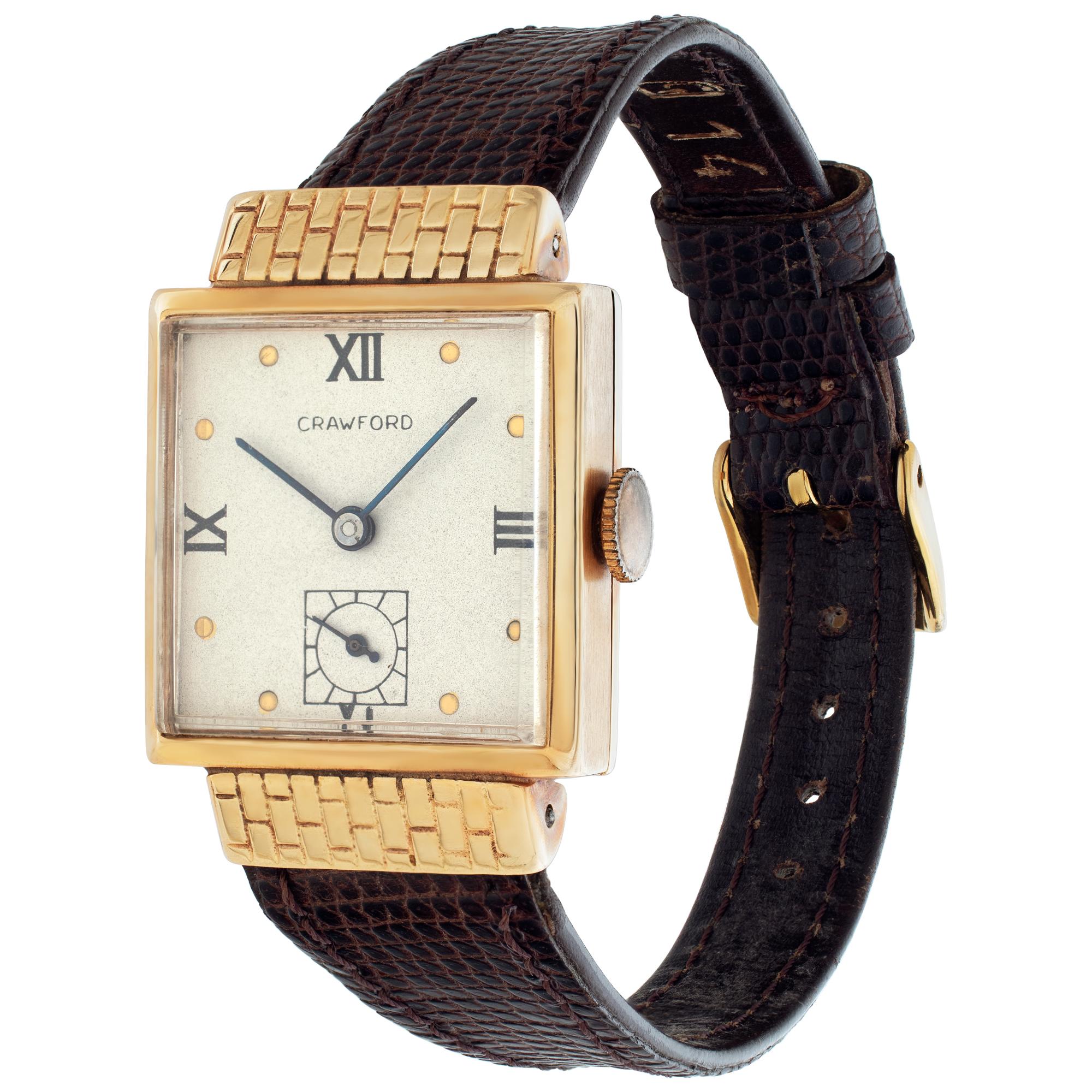 Unisex Crawford 14k yellow gold manual wind watch with 14k bezel and leather leather band with two piece clasp.Subsidary Seconds Hand. Caliber 17 jewel movement. Certified pre-owned. Presentation watch 1945 Fine Pre-owned Crawford Watch. Certified