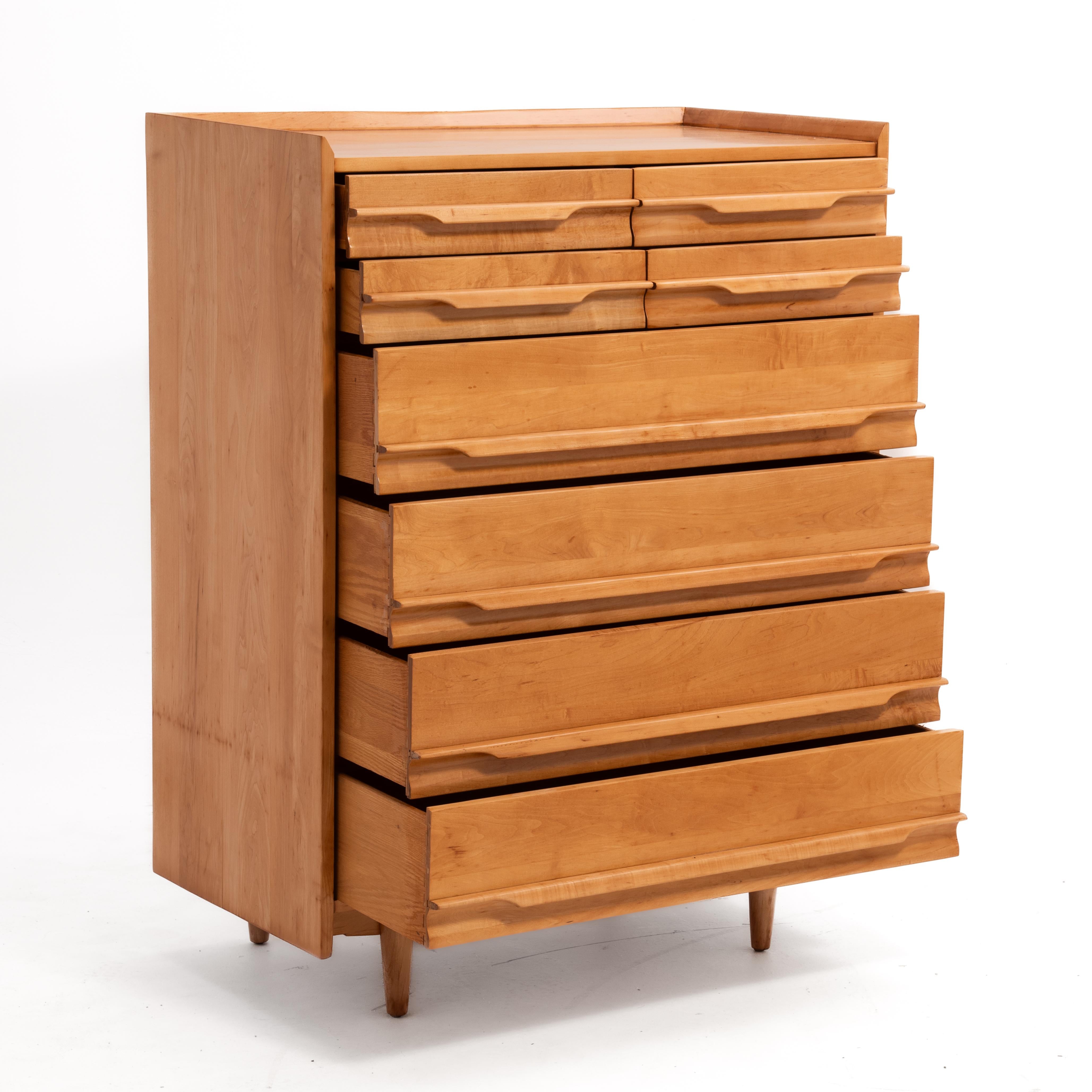 A Mid Century maple chest of drawers made by Crawford Furniture of Jamestown, New York. Two sets of two drawers over four drawers that feature long, elegant handles with hidden pulls. Solid maple throughout. The design of this piece is influenced by