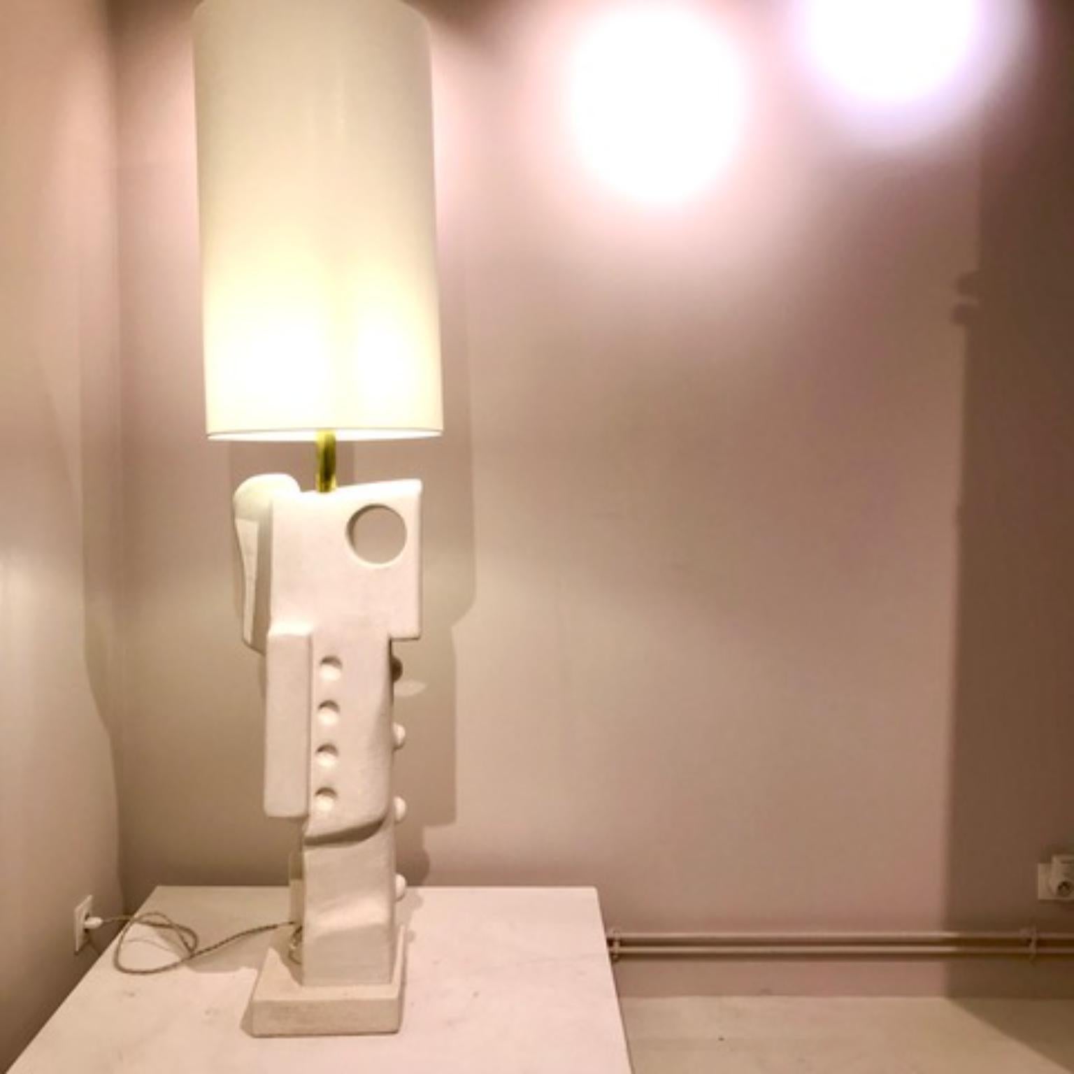 Clay Floor Lamp by Frederic Texier
Dimensions: W 32 x D 26 x H 172 cm. 
Materials: Concrete coated with lime and cement Metal part : brass Lampshade : linen. 
Color: Clay.

Artist Frédéric Texier expresses a passion for craftsmanship through his
