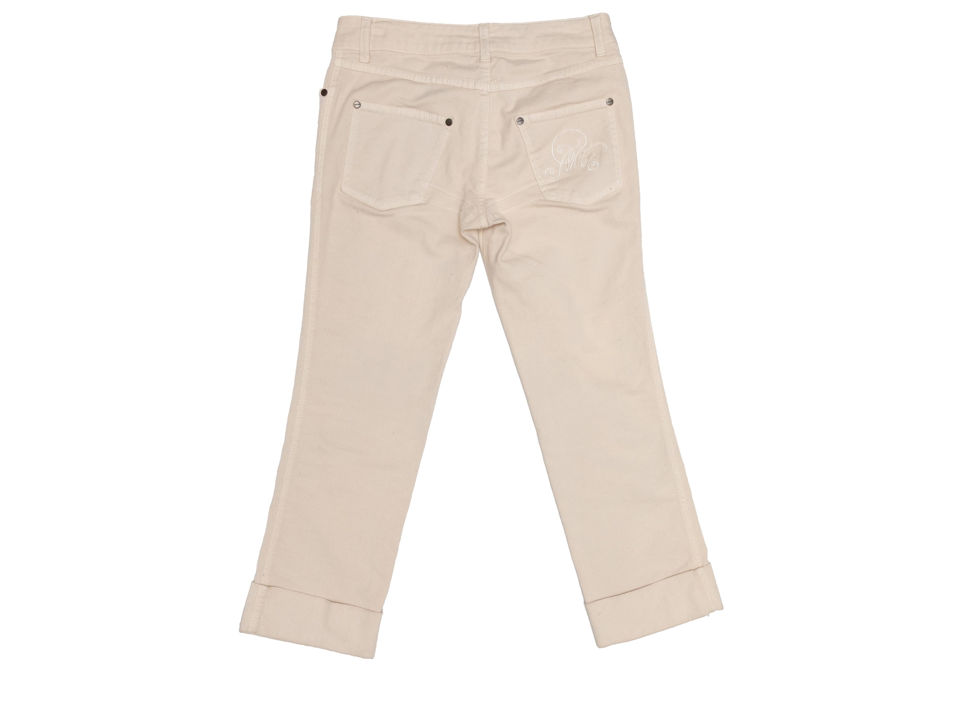 Cream cropped jeans by Alexander McQueen. Five pockets. Zip and button closures at front. 34