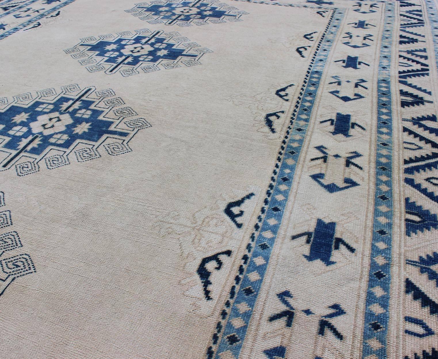Cream and Blue Geometric Four Medallion Design Vintage Turkish Oushak Rug In Good Condition For Sale In Atlanta, GA