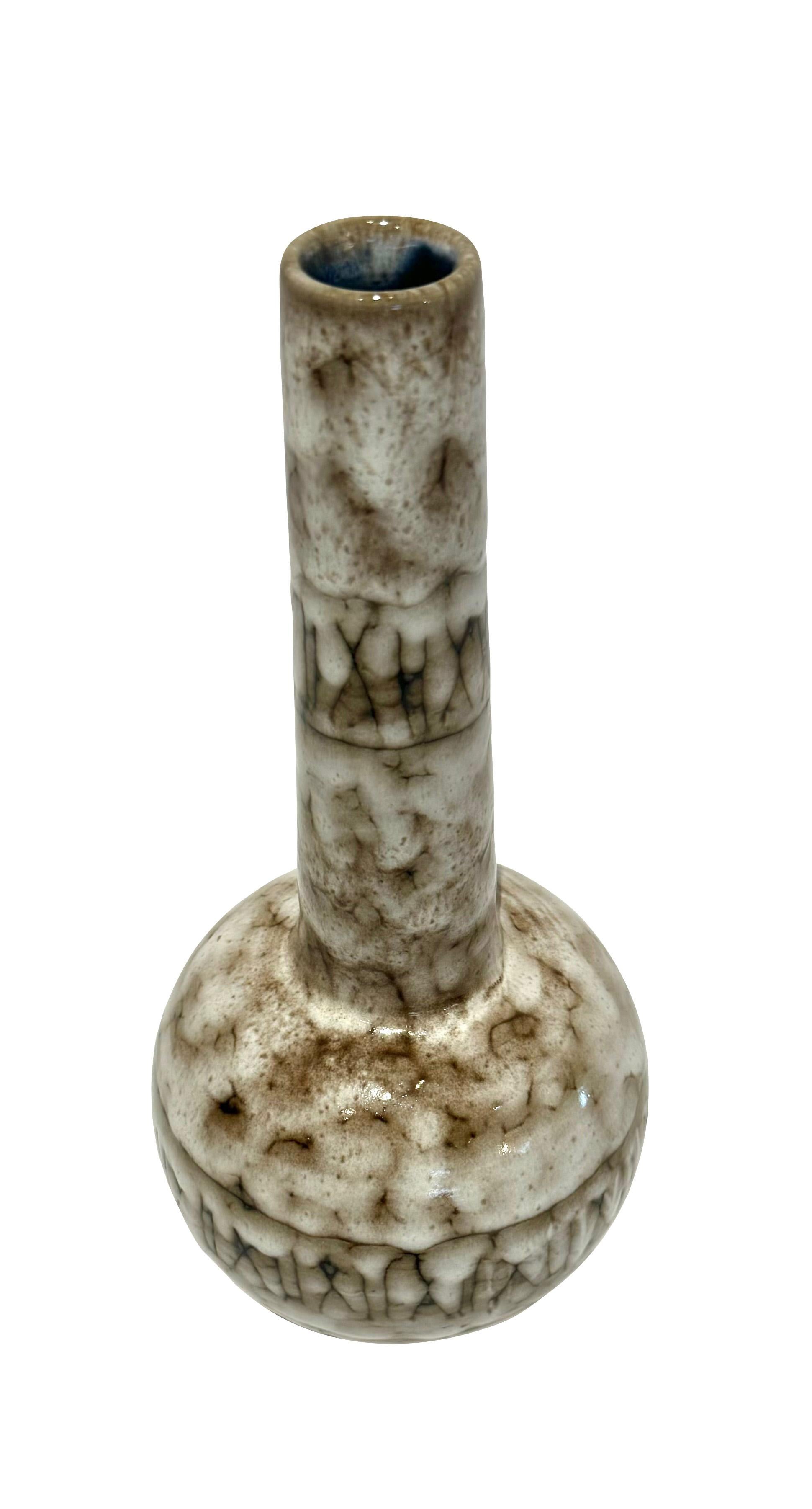 1940's Hungary cream and brown vase.
Tall thin tubular neck with X design.
Interior has a cobalt blue glaze which peaks out from the neck opening.
The glaze has a slight texture.
Part of a large collection.