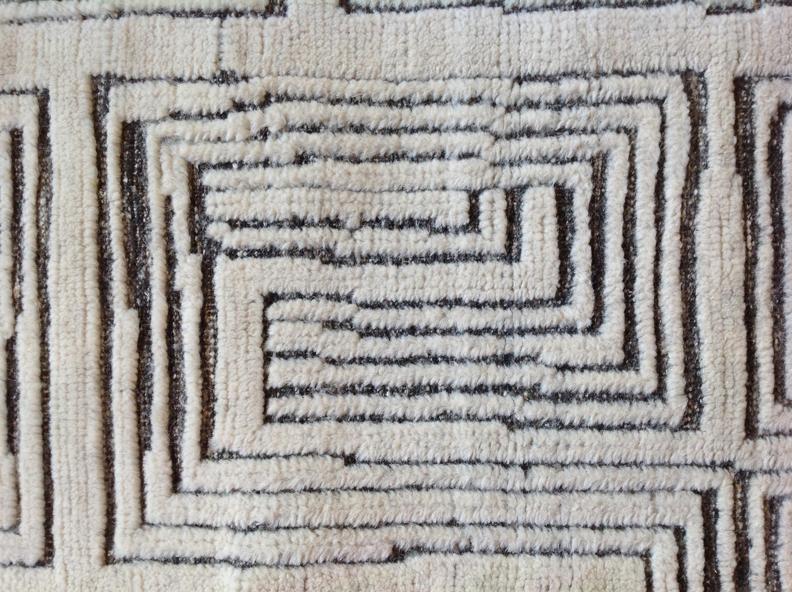 Low cut cream fibers against a charcoal weave make for an intriguing and stylish contemporary rug. Wool. Made in India using natural dyes.