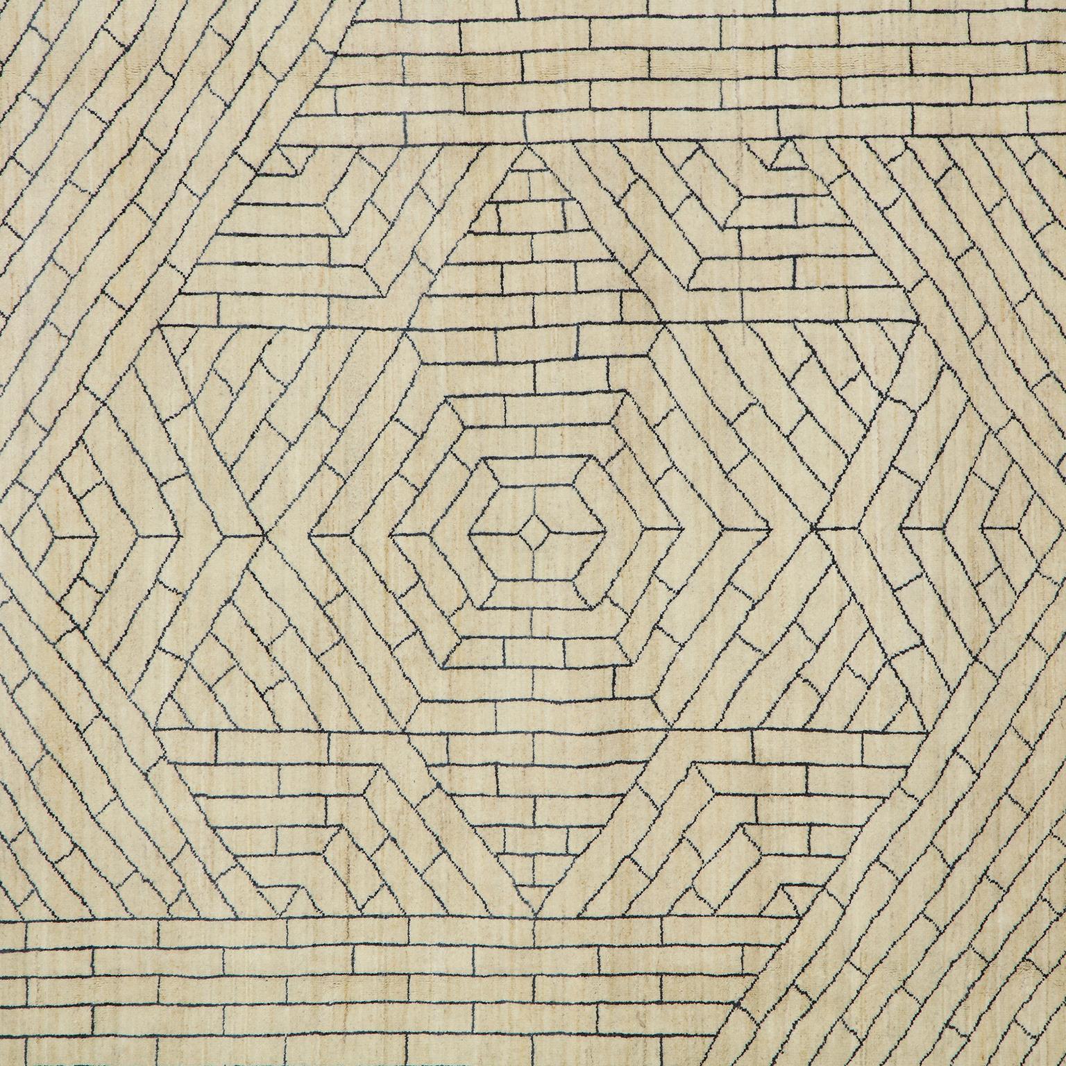 A cream background and gray design make this modern area rug shine with its geometric design. Created by Orley Shabahang using the techniques that had been utilized for generations in carpetmaking, the design actually derives its influence from the