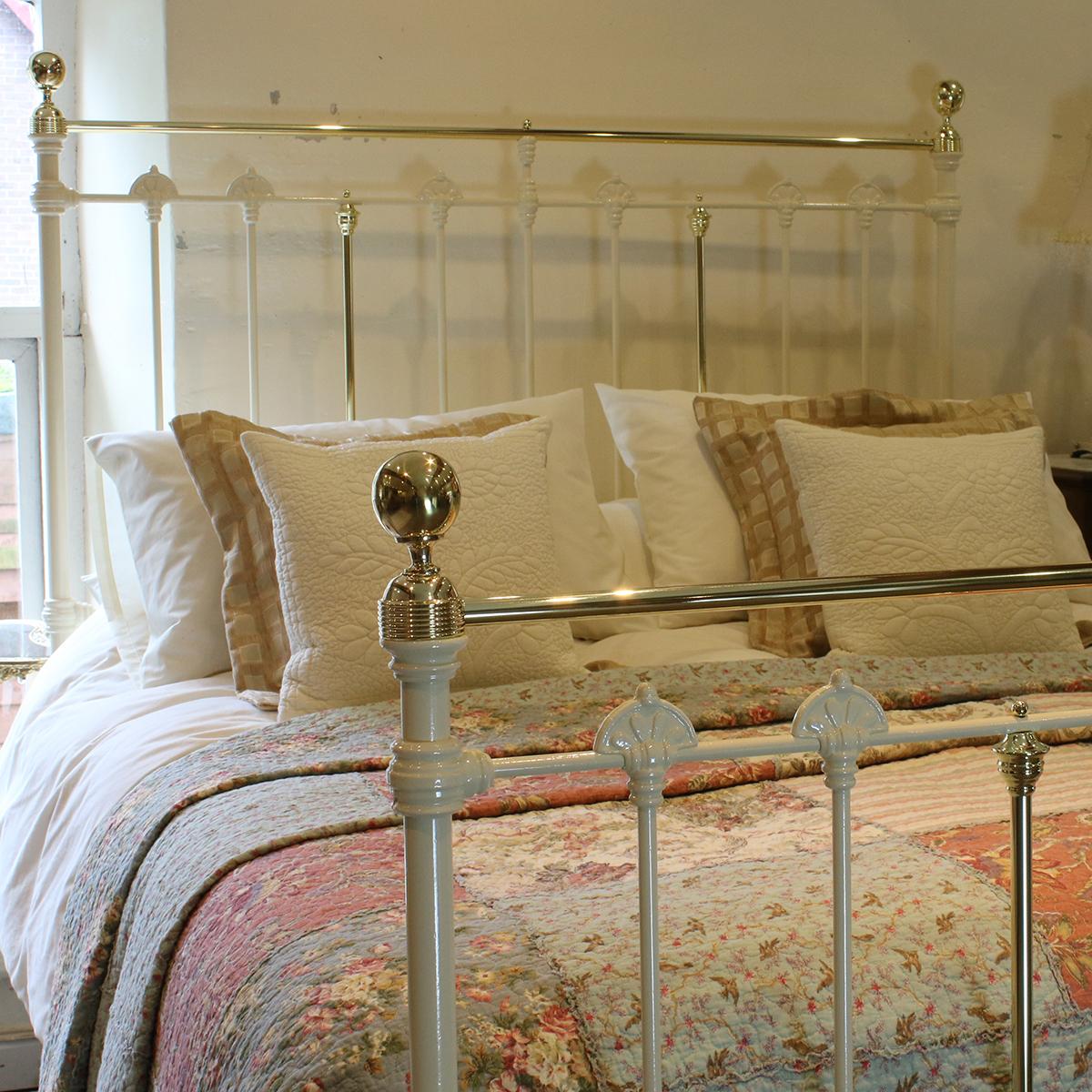 Antique bed in cream with straight brass top rail, brass knee-caps, knobs and collars, and large decorative castings. 

This bed accepts a UK King size or US Queen size (5 ft, 60 in or 150 cm wide) base and mattress set.

The price is for the