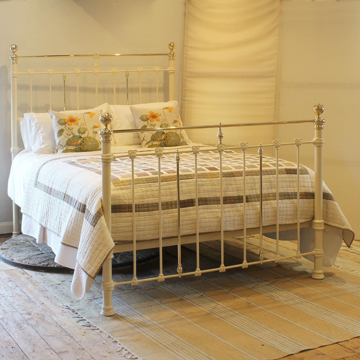 An attractive cast iron antique bed finished in cream with straight brass top rails and decorative castings depicting Art Nouveau floral designs.

This bed accepts a UK king size or US queen size (5ft, 60in or 150cm wide) base and mattress set.

The