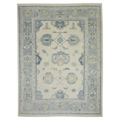 Tapis turc Oushak en laine tissée à la main, crème et bleu, à motifs floraux 7' x 9'.