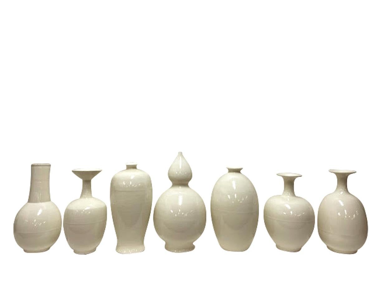 Contemporary Chinese bottle shape cream ceramic vase.
One of several shapes and sizes from a
great collection for many decorative end uses.
Beautiful milk white/cream color. 
 