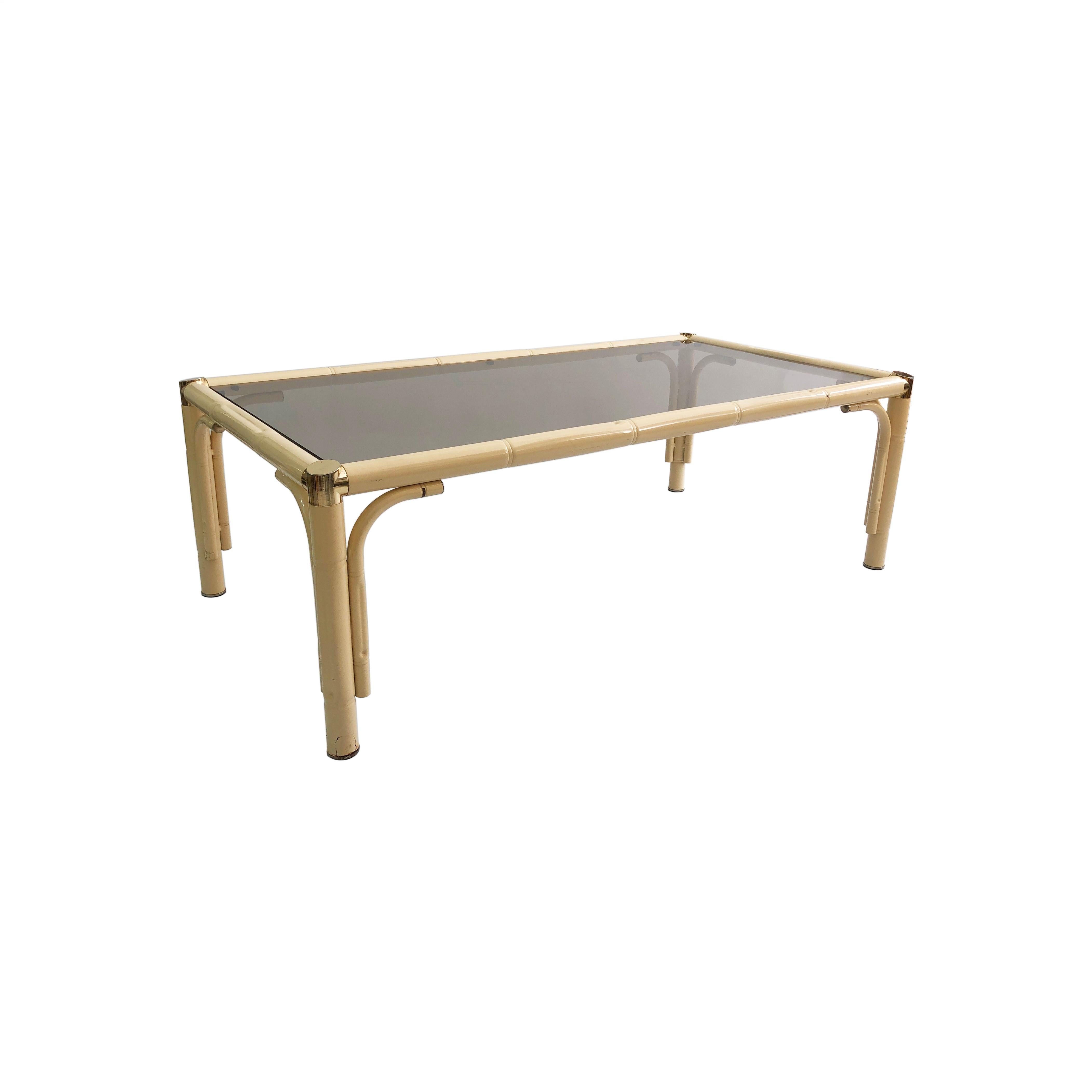 A splendid coffee table of glass and faux-bamboo, that has its provenance in 1970s Italy and whose muted cream tones would make a stylish centrepiece for any room. A tubular powder-coated metal frame houses a rectangular pane of smoked glass, with