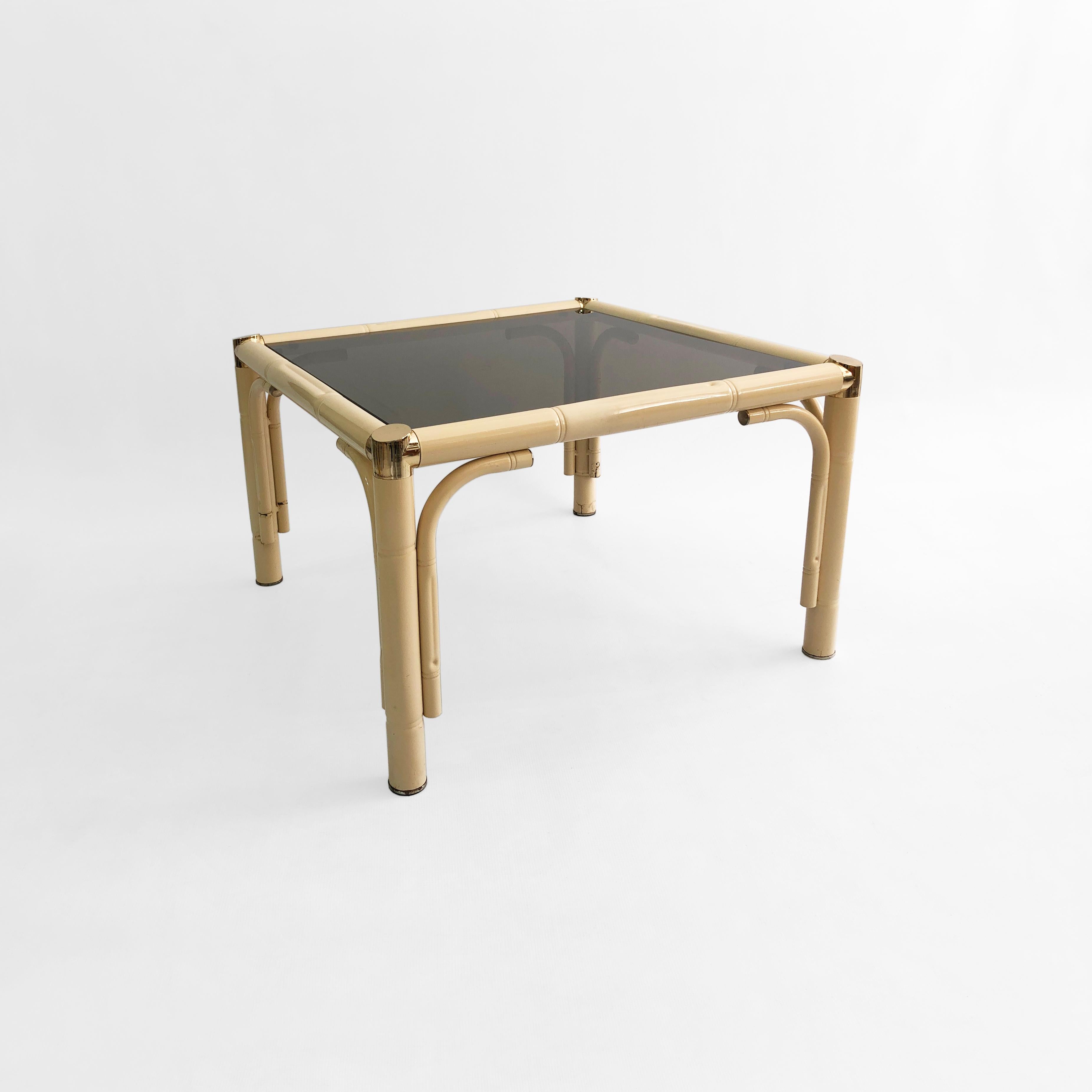 Une splendide table d'appoint en verre et faux-bambou, dont l'origine remonte à l'Italie des années 1970 et dont les tons crème atténués constitueraient un ajout élégant à n'importe quelle pièce. Un cadre tubulaire en métal peint par poudrage abrite