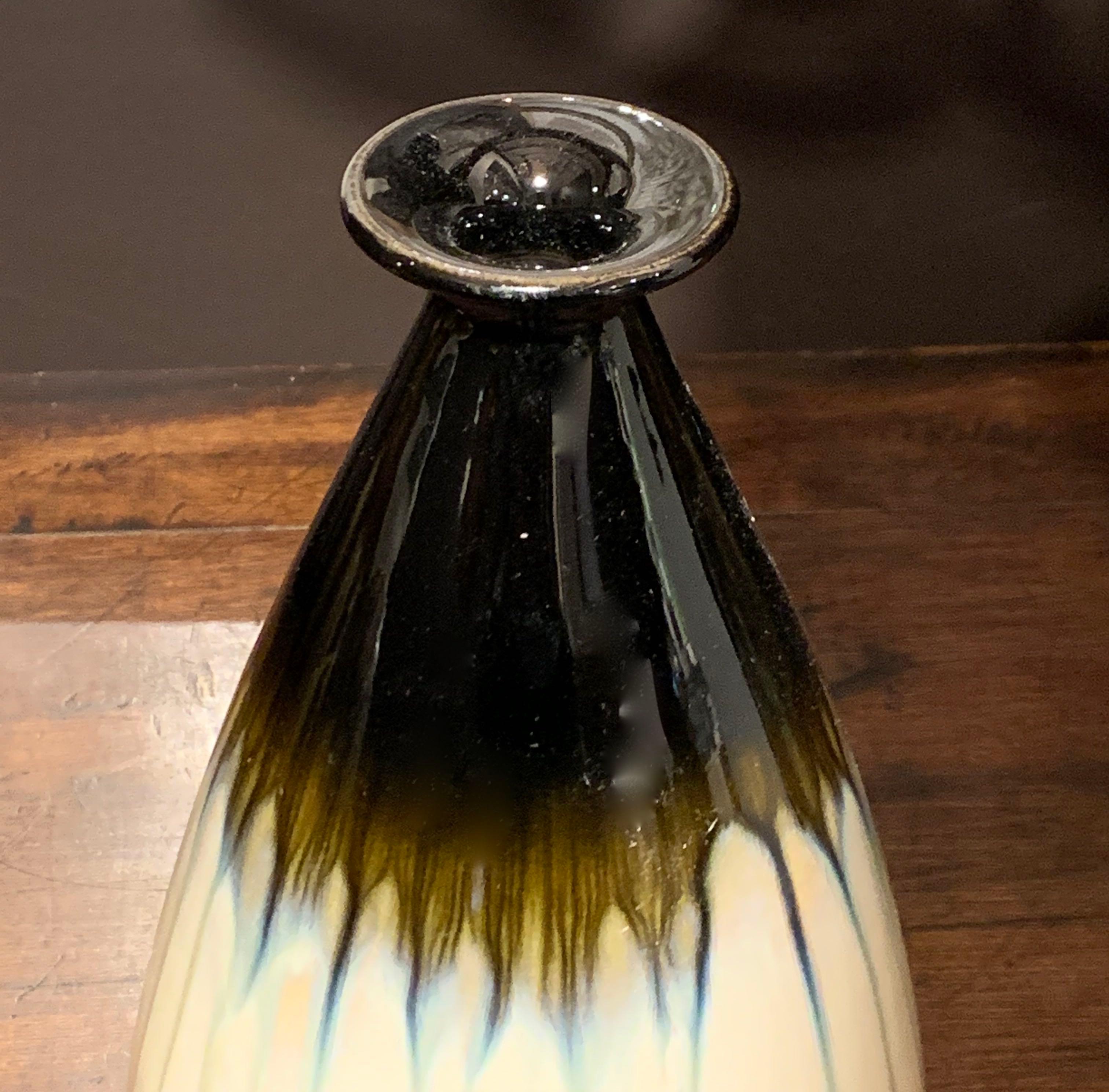 Contemporary Chinese ceramic vase with decorative drip glaze.
Cream ground with shades of brown and black.
Dark brown at the top and bottom with a cream center and light brown horizontal drip glaze.
  
 