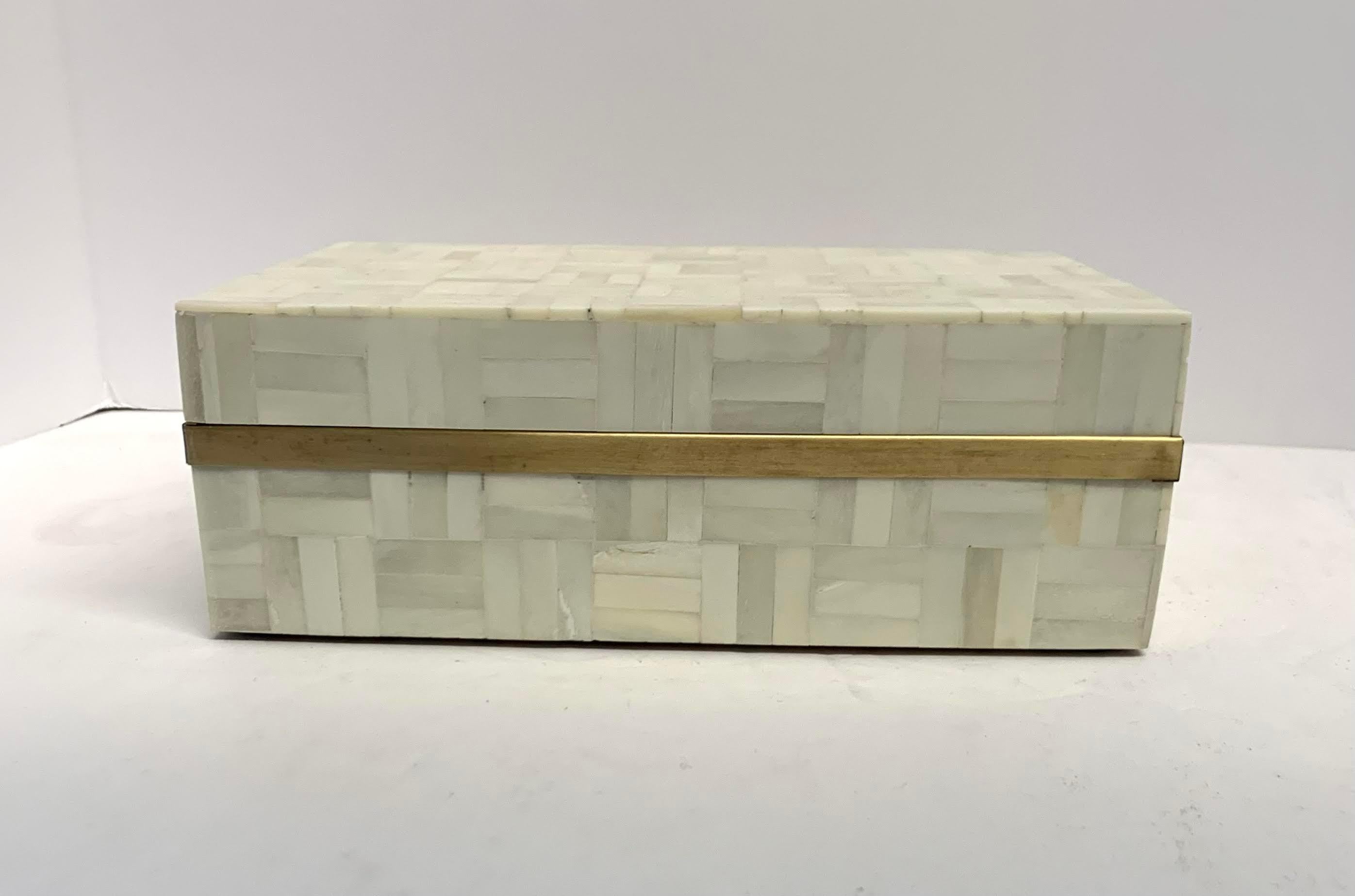 Contemporary Indian cream color lidded bone box with gold strip surround.
Strips of bone are inlaid to create a color on color checkerboard pattern.
Part of a large collection of bone boxes and trays