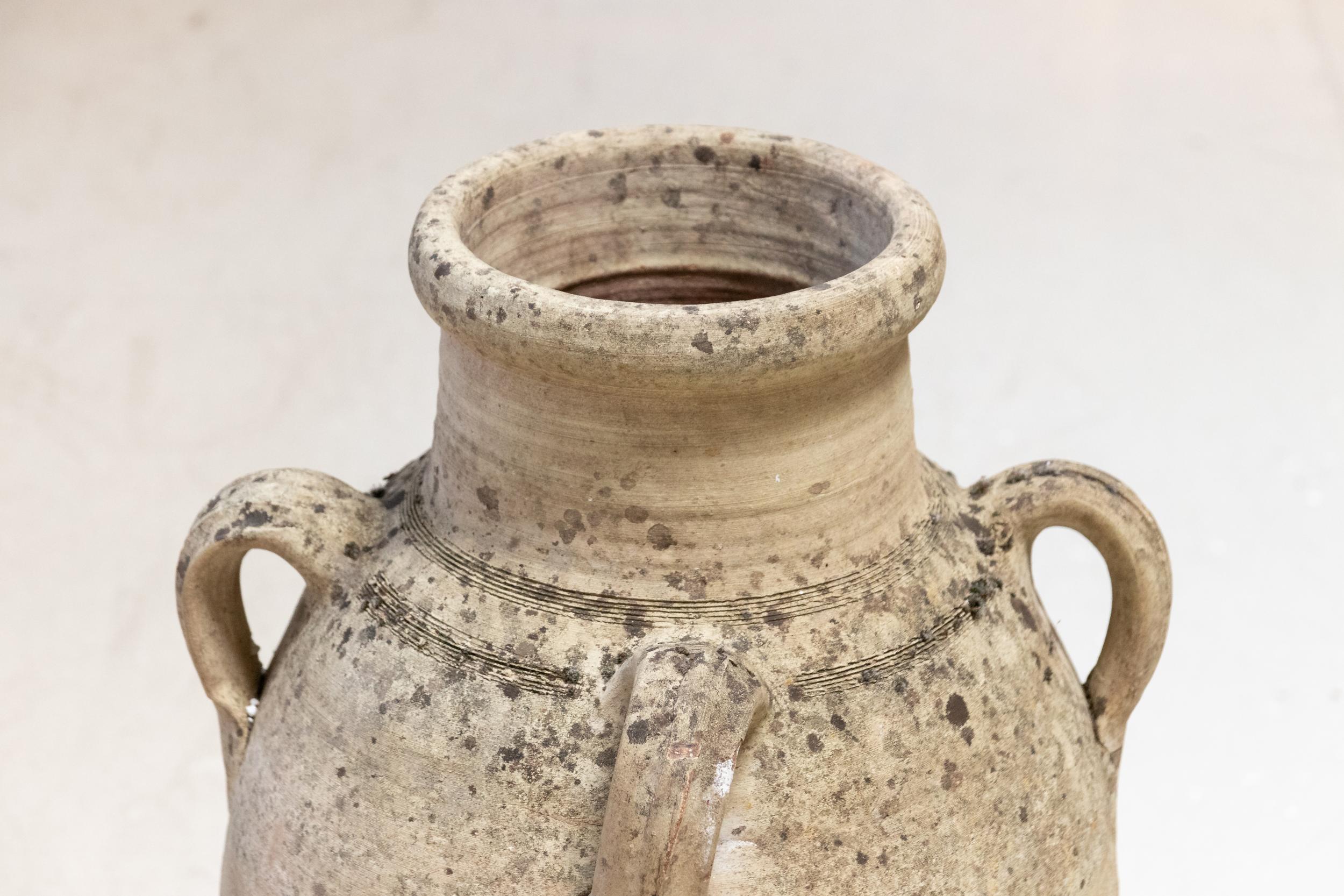 20th century large, round handled amphora vase. Please note of wear consistent with age including weathered finish, discoloration, and minor losses due to exposure to the elements.