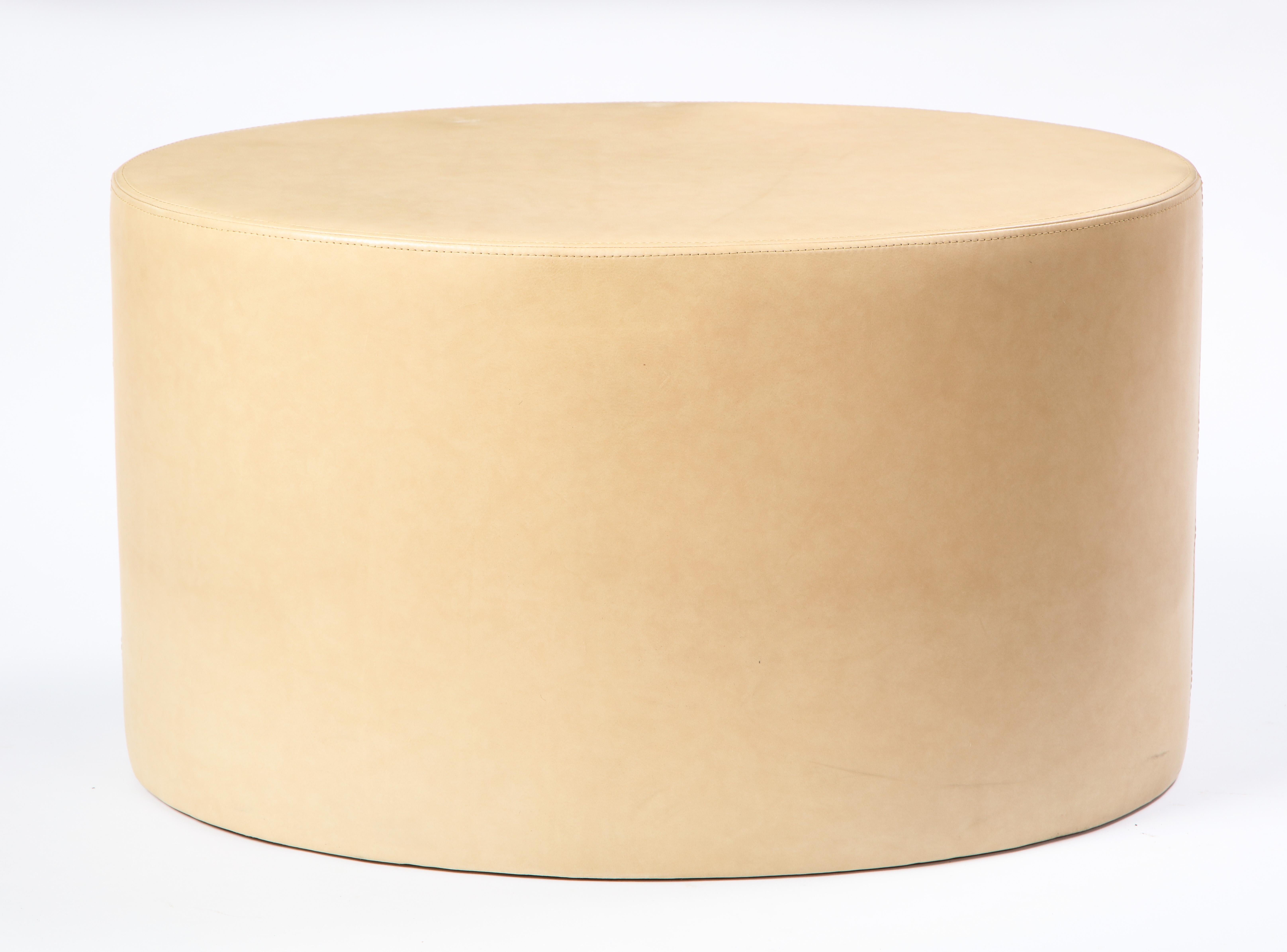 Modern cream-colored leather low table or ottoman. Oval in shape, this topstitched leather-covered low table adds a warm touch to any modern seating arrangement and is perfect as a side or coffee table for any living room or lounge area.

Property
