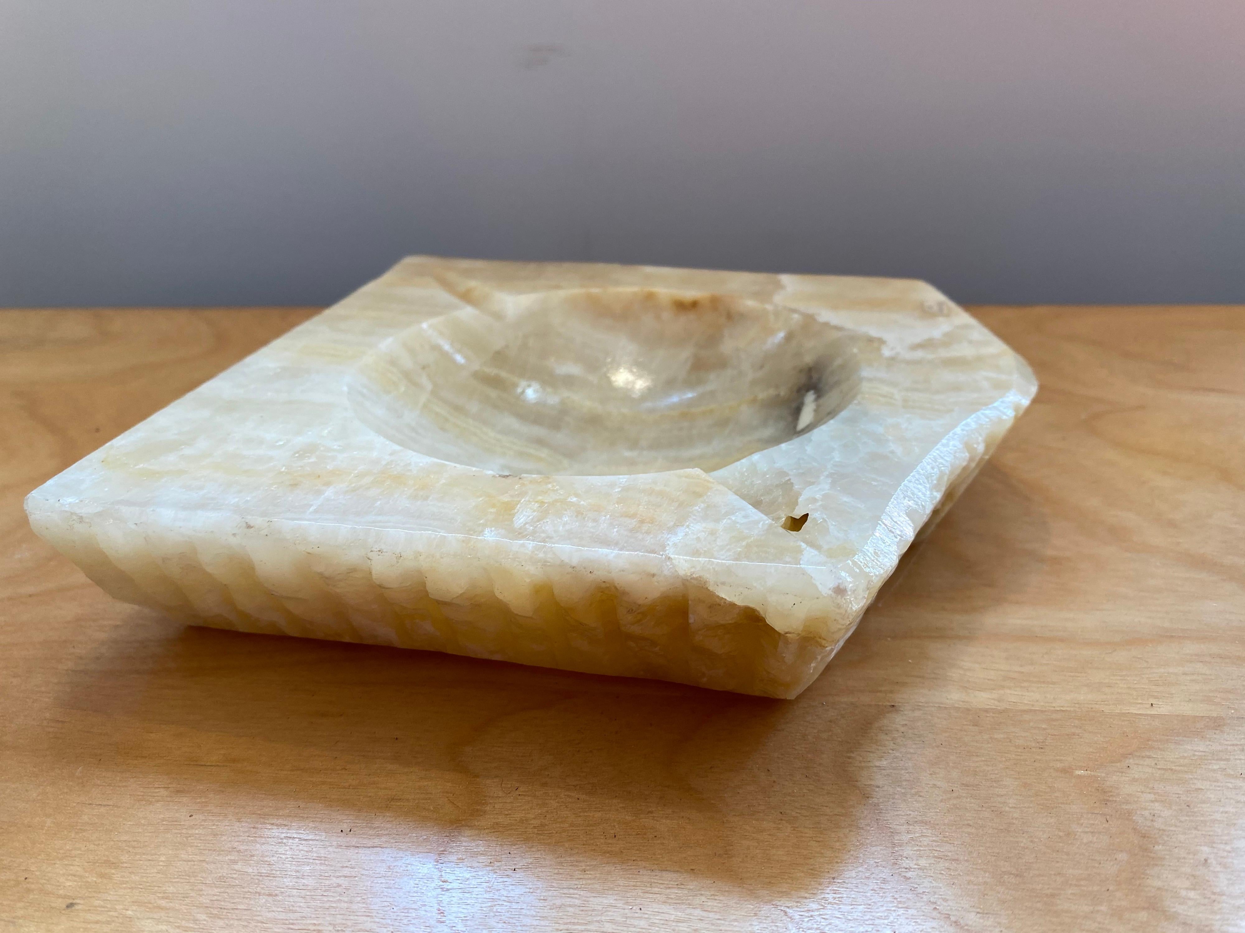 Roughly square shaped rough edged marble ashtray.