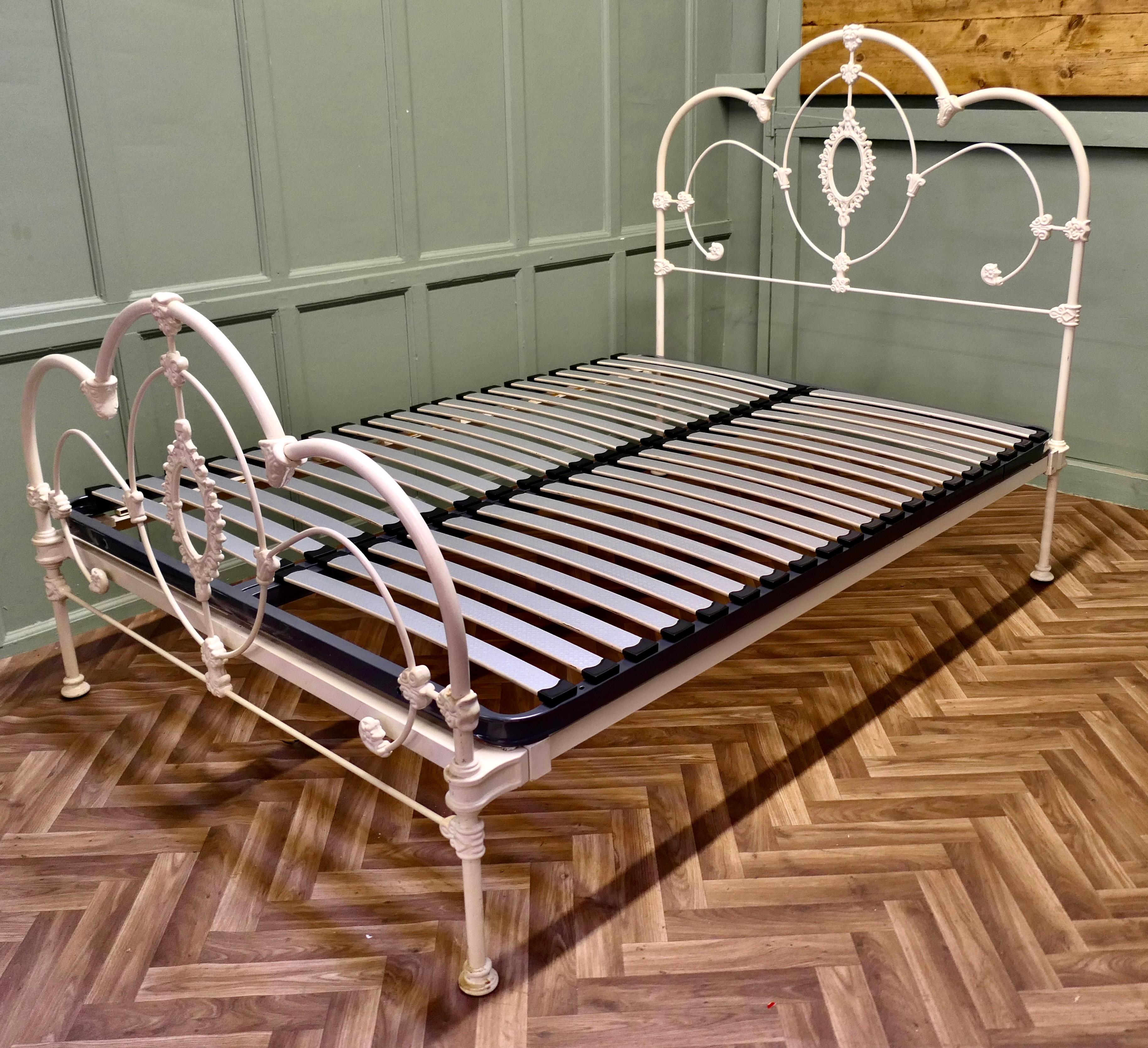 Cream Coloured Wrought Iron Bed Double Bed
This is a very attractive Victorian style bed it has a curved  design with a cast iron wreath at the centre This is a very attractive bed it is in good sound condition. The bed come with a new slatted base