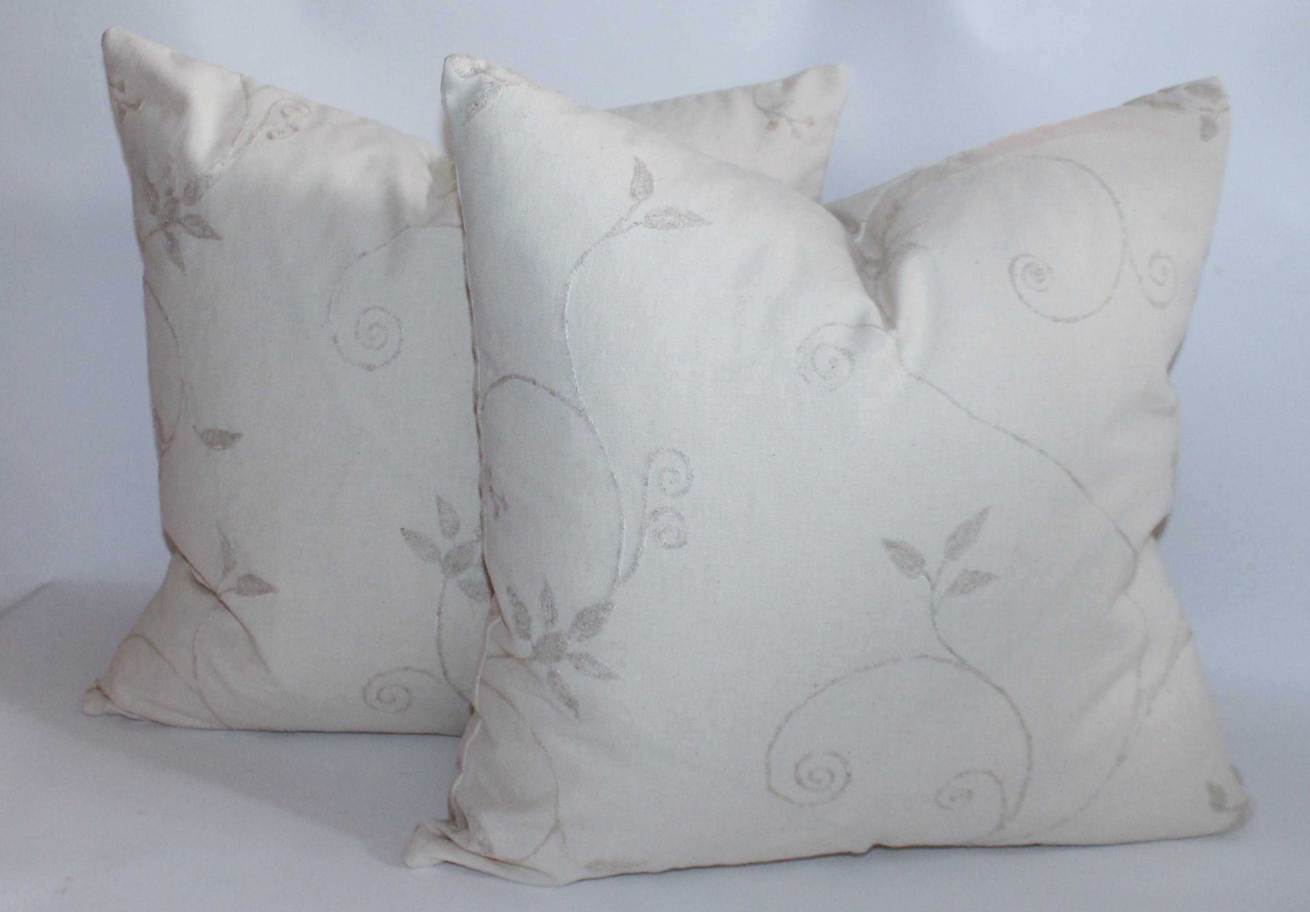 Cream crewel work pillows in a collection of four. Reversible fabric both front and back. They are down and feather fill.