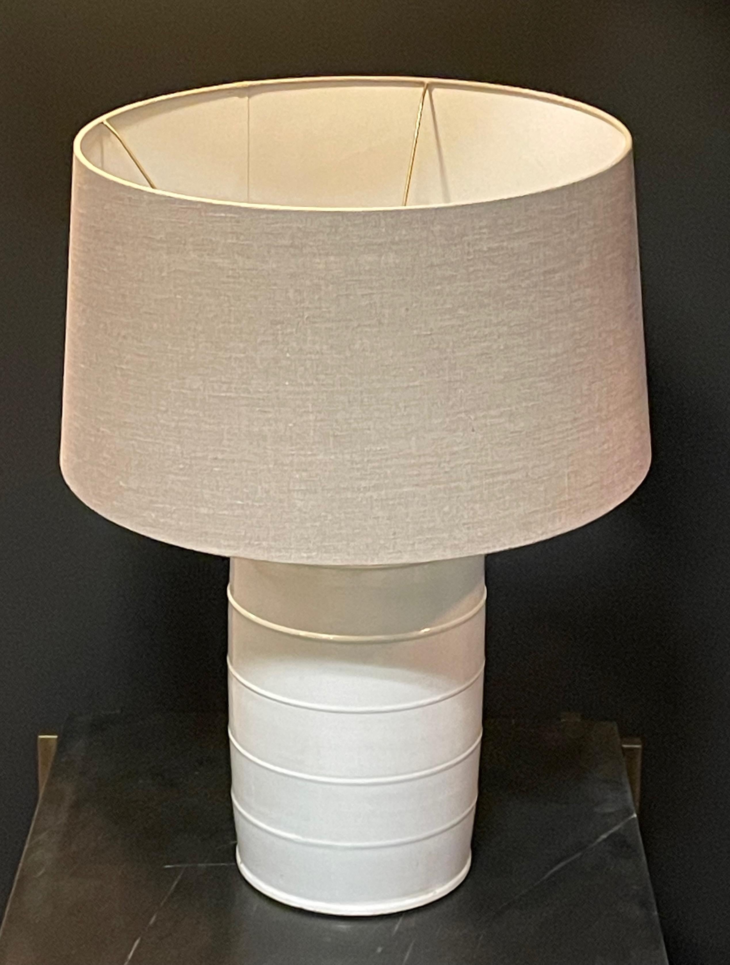 Contemporary Chinese pair of cream colored canister lamps.
Decorative four band design.
Linen shades included.
Base measures 9 
