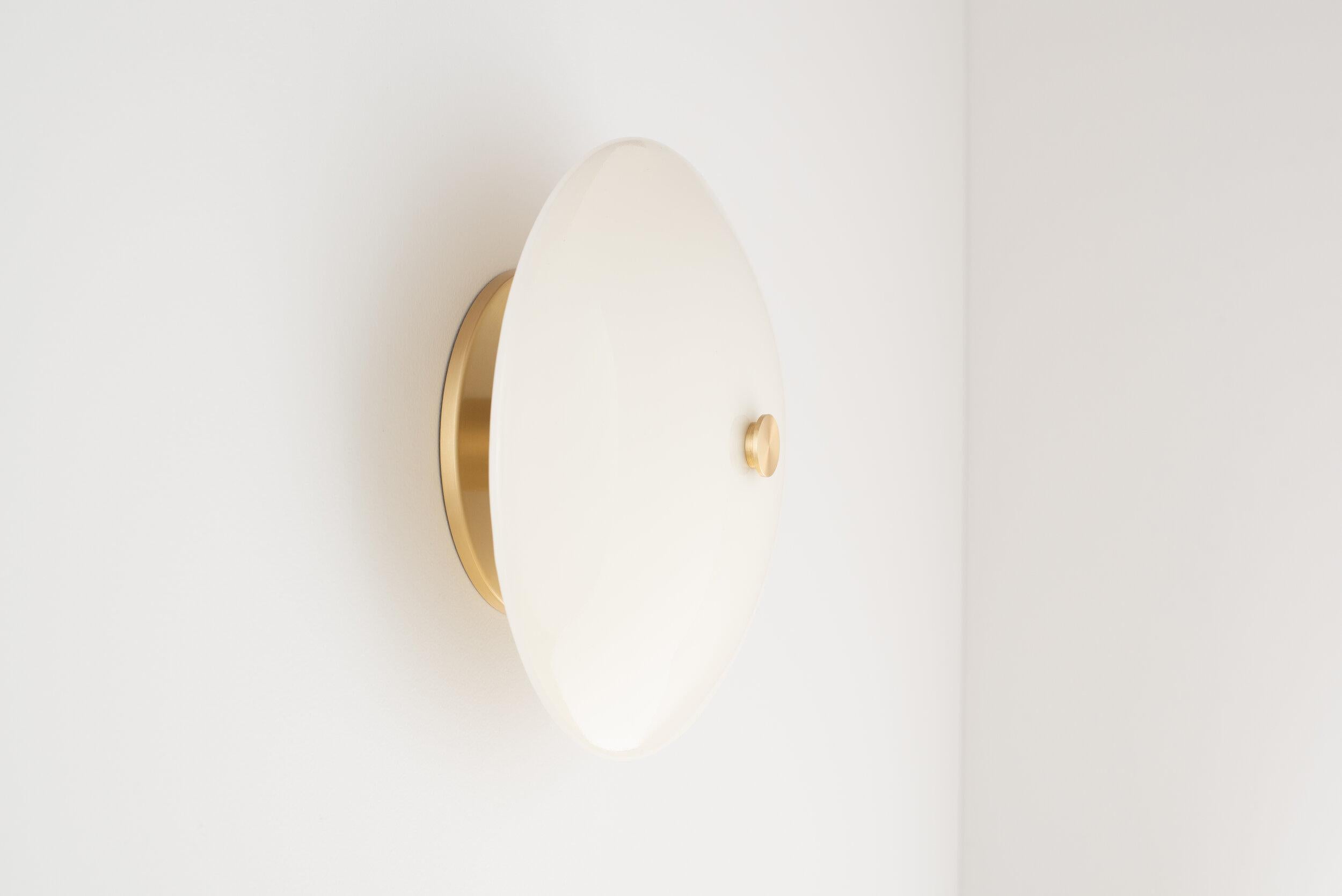 A modern dome of hand poured and slumped glass floats effortlessly off the wall providing distinct dimmable illumination. 

The Lyra sconce is available in multiple glass colors and illuminated by a 120V AC direct drive led module with no external