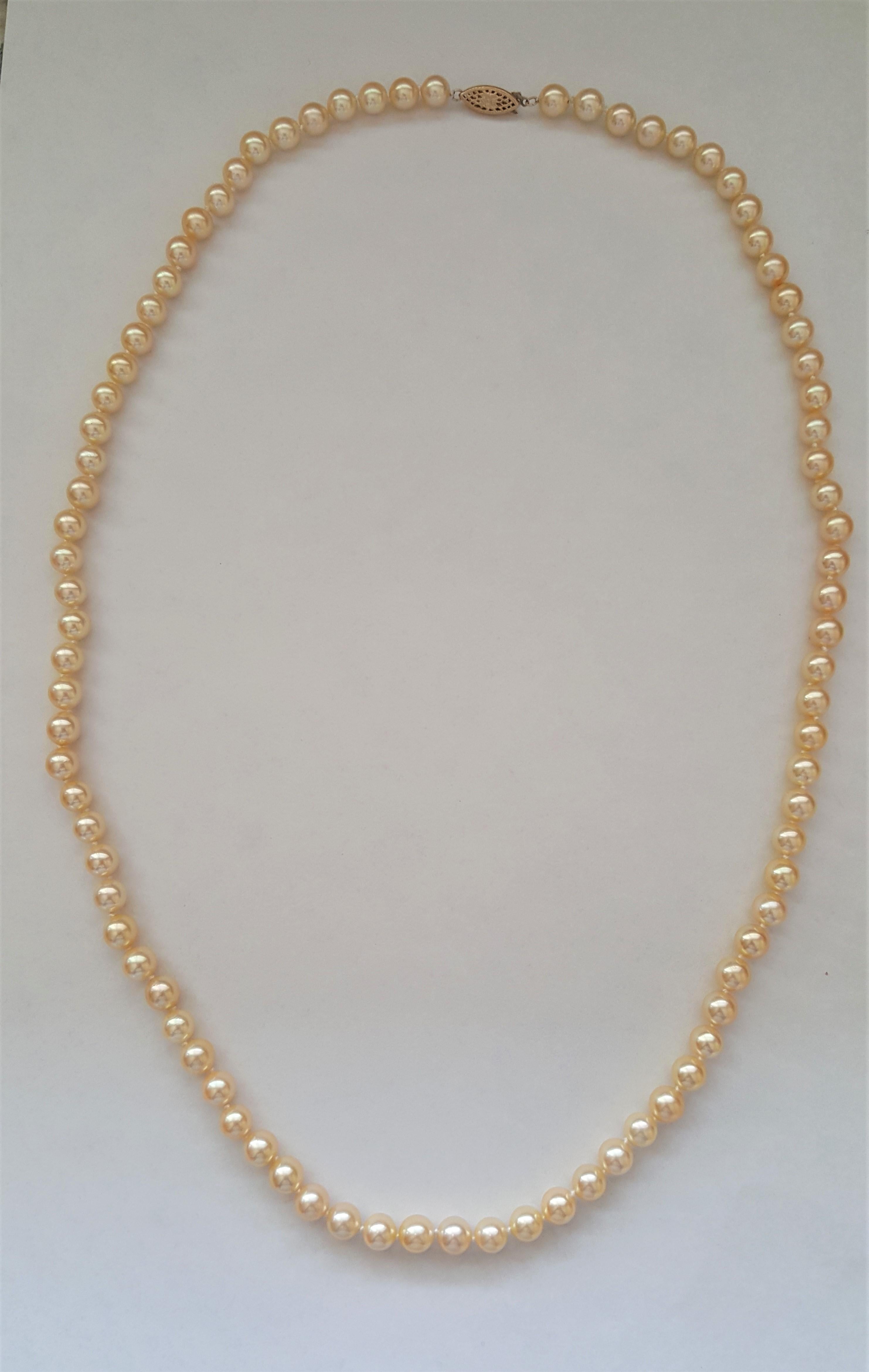 A beautiful grade AAA cultured pearl set with rich cream gold pearls that are 7+mm in size. The necklace is 27 inches long, secured with a 14k yellow gold filigree pearl clasp, stamped. The bracelet has a 14kt yellow gold decorative clasp that's