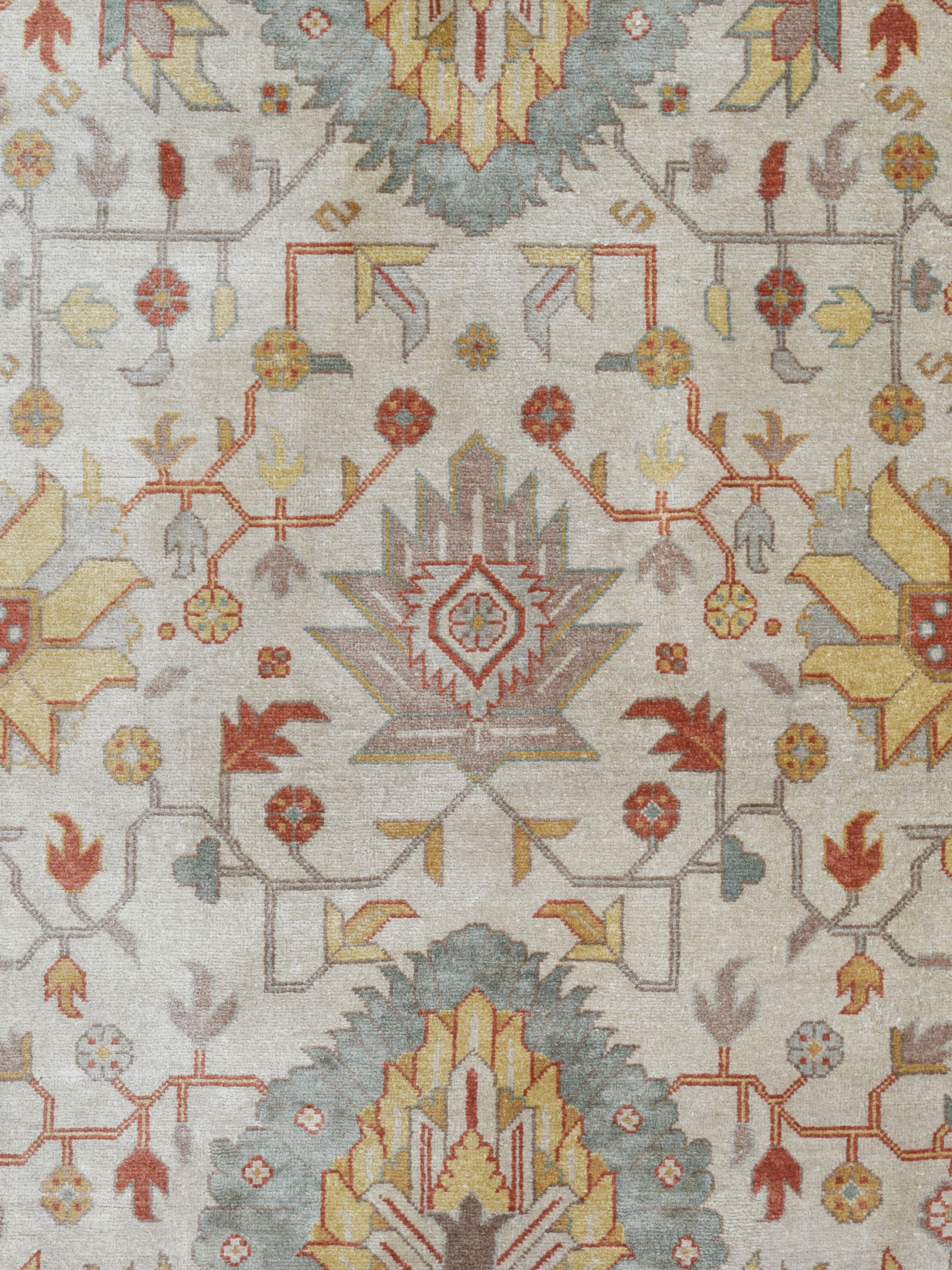 From the Orley Shabahang collection and handknotted in khazar silk, this 5'x7' Persian area rug utilizes a harmonious tableau of cream, gold, and green. The intricate artistry typical of Tabriz designs, featuring thoughtfully placed botanical motifs