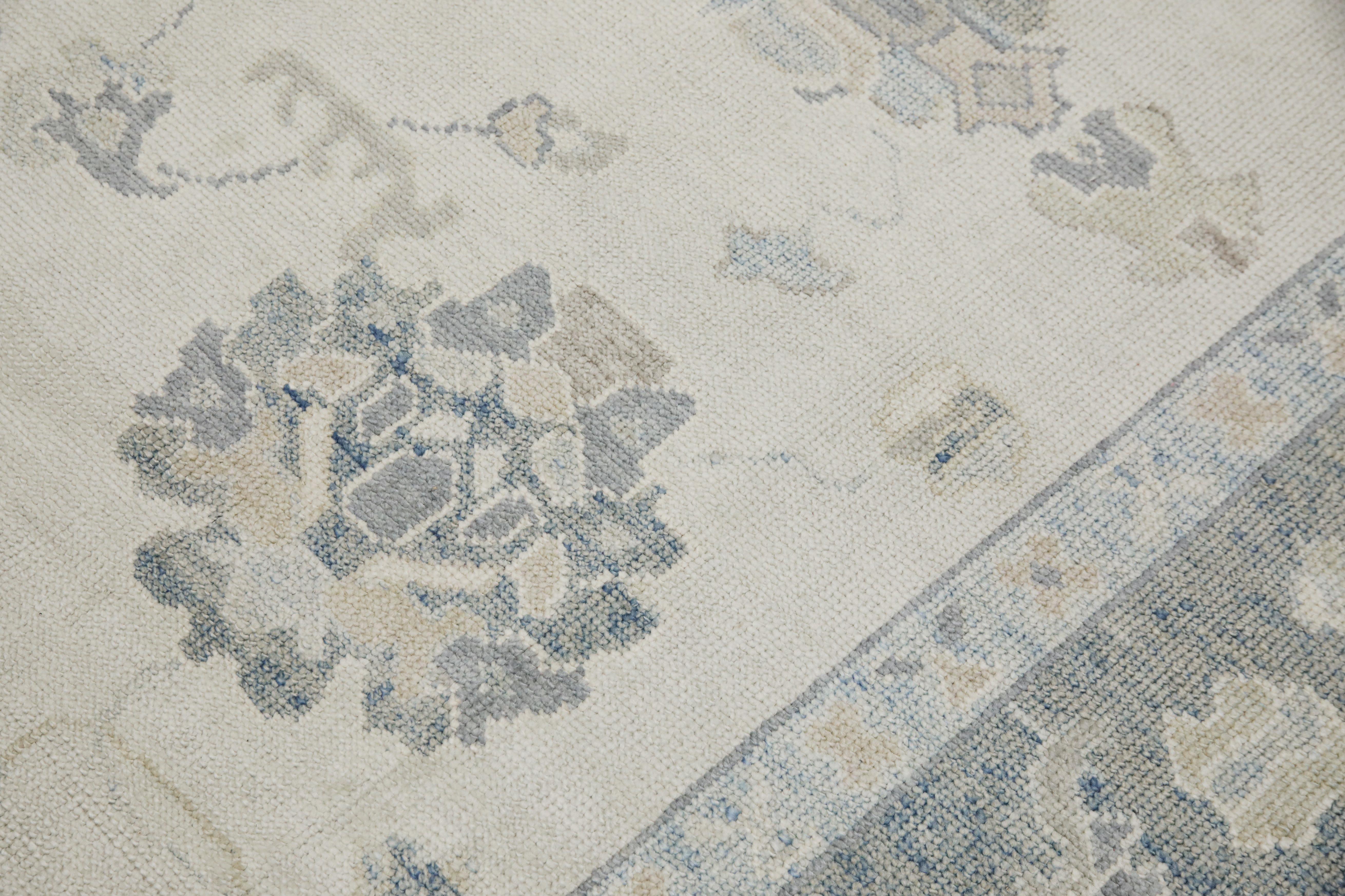 This modern Turkish Oushak rug is a stunning piece of art that has been handwoven using traditional techniques by skilled artisans. The rug features intricate patterns and a soft color palette that is achieved through the use of natural vegetable
