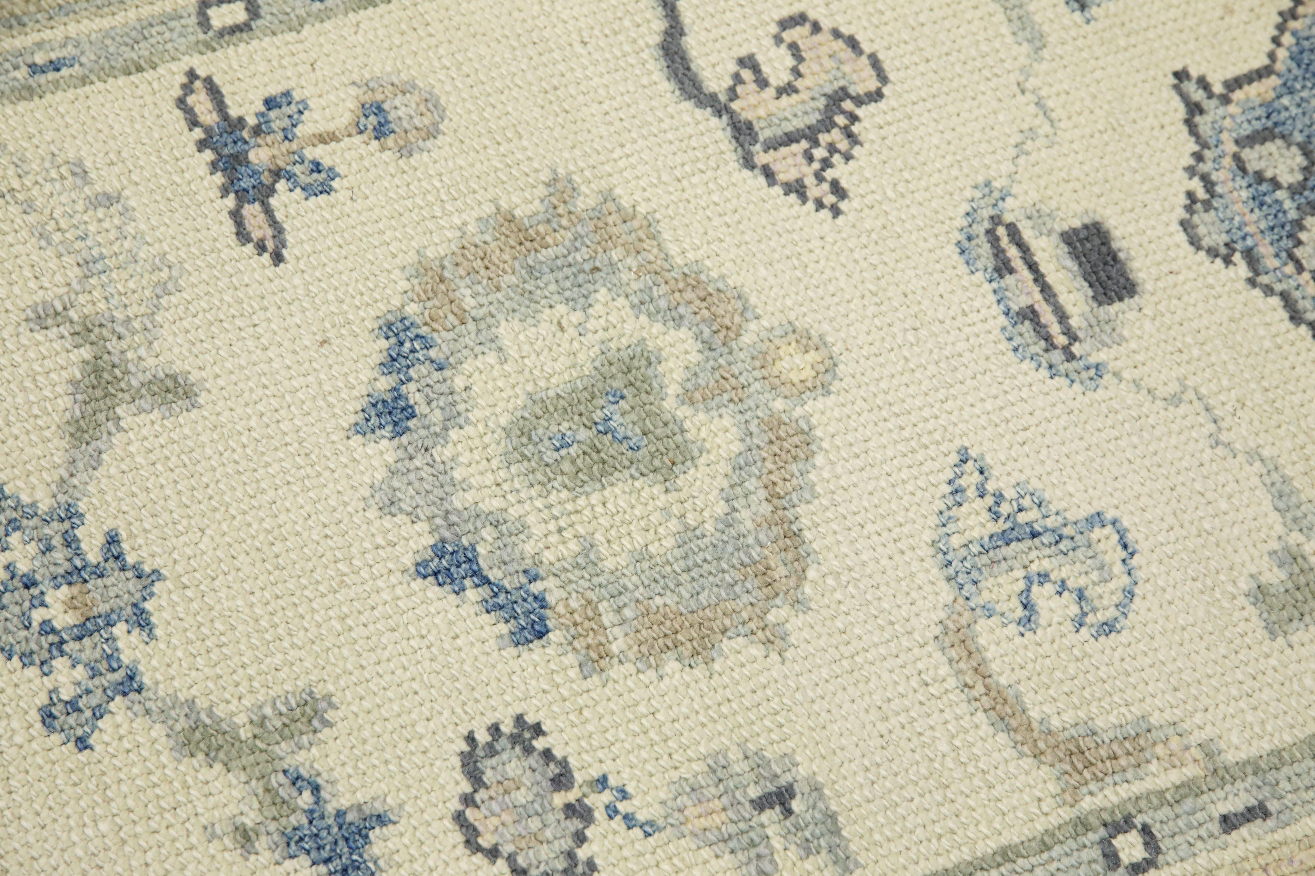 This modern Turkish Oushak rug is a stunning piece of art that has been handwoven using traditional techniques by skilled artisans. The rug features intricate patterns and a soft color palette that is achieved through the use of natural vegetable