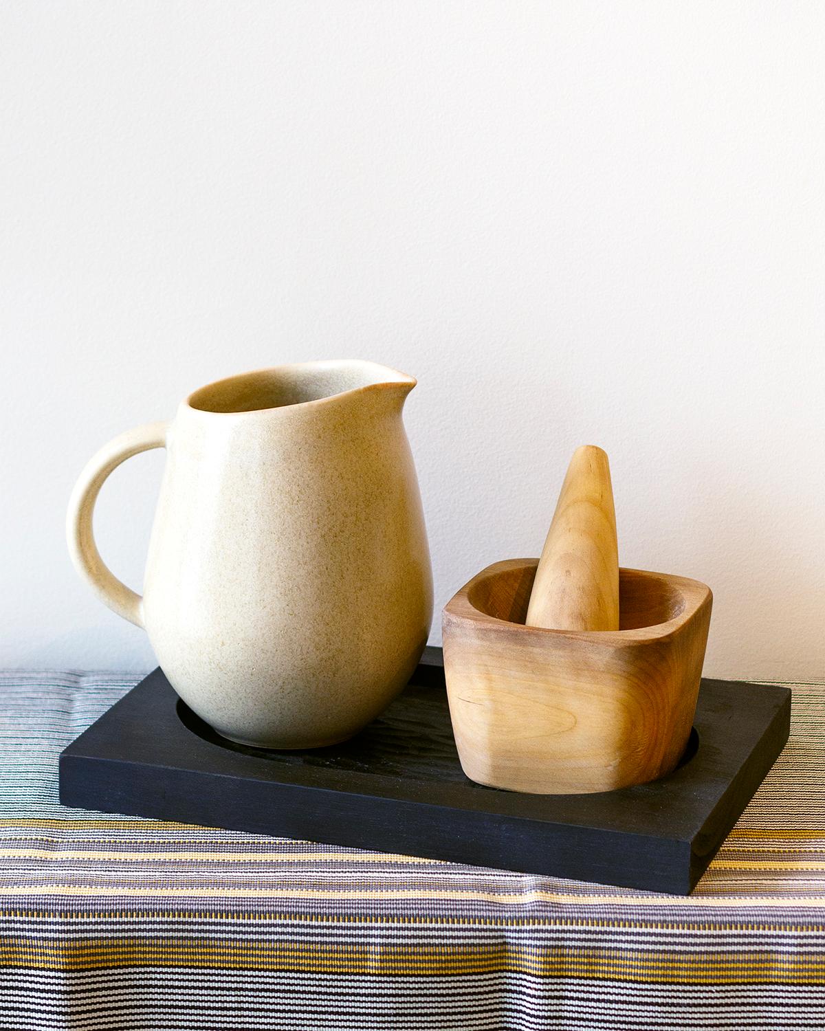 A stoneware pitcher to serve your favorite drinks. This handmade stoneware pitcher will bring the perfect touch of modern minimalism to your home. Its subtle cream and ivory glazes add organic texture and rustic charm to any decor. Great for serving