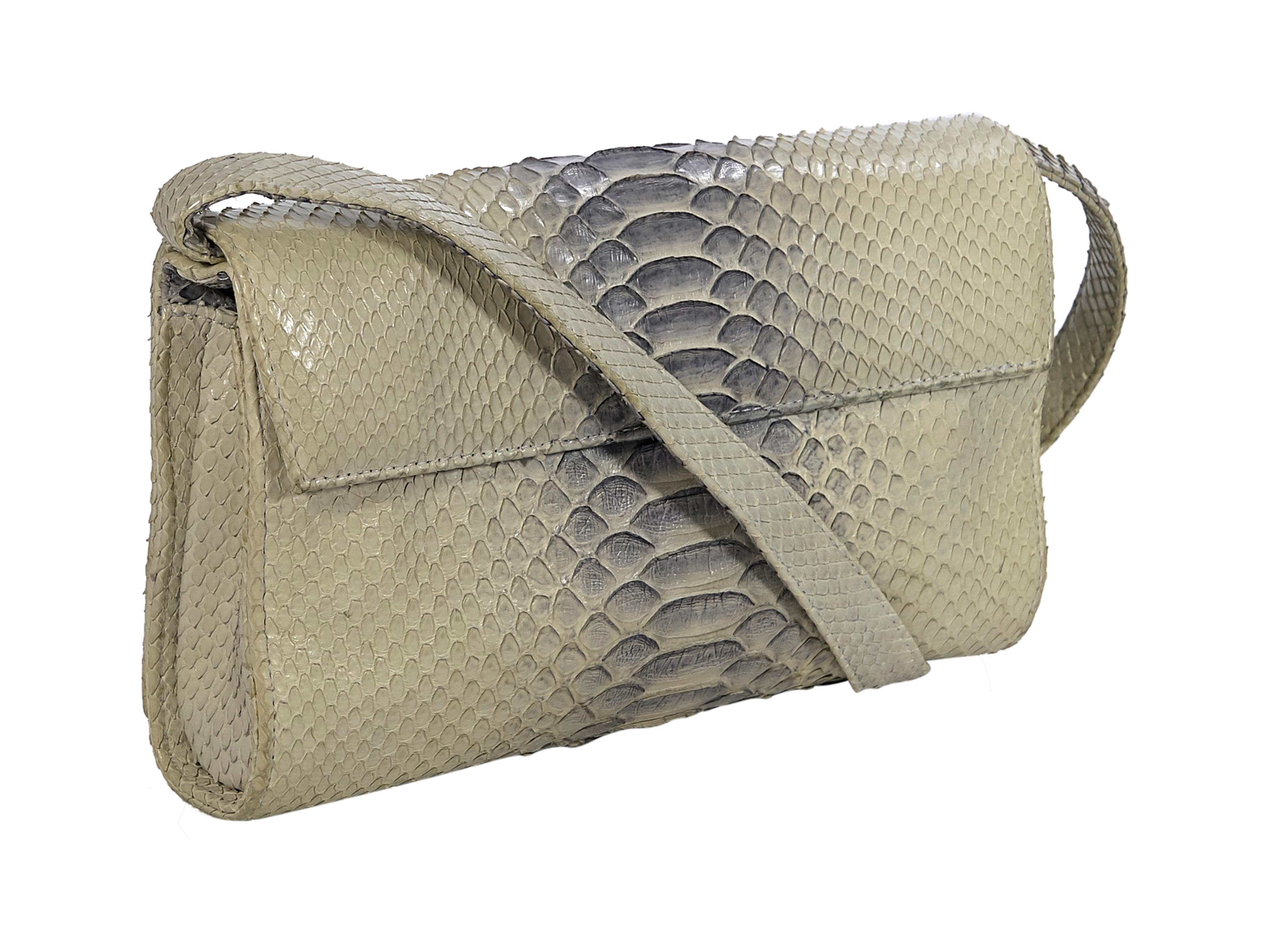Product details: Cream leather snakeskin shoulder bag by Hayward. Adjustable shoulder strap.  Front flap with concealed magnetic snap closure. Lined interior with slide pocket. Silver-tone hardware. Wear crossbody with a linen midi skirt. 9