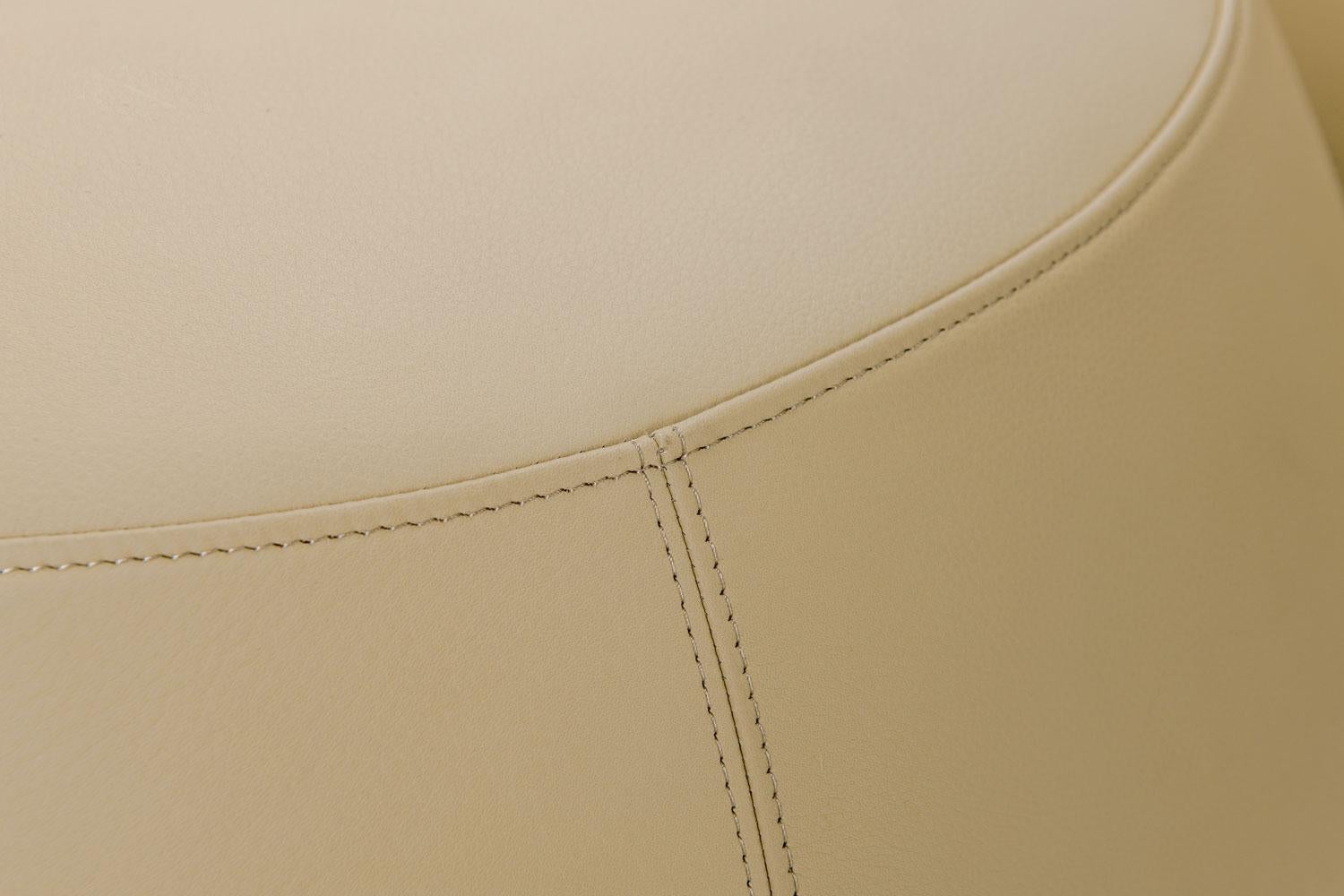 round cream leather ottoman