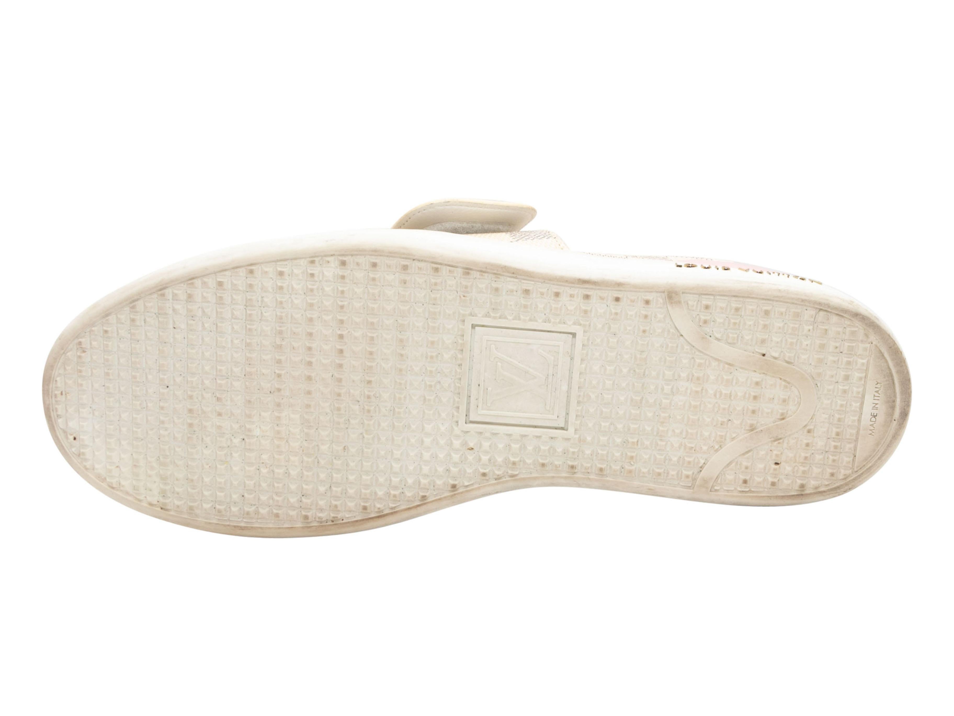 Cream and multicolor Damier Azur luggage motif low-top sneakers by Louis Vuitton. Rubber soles. Lace-up tie and strap closures at tops. 1