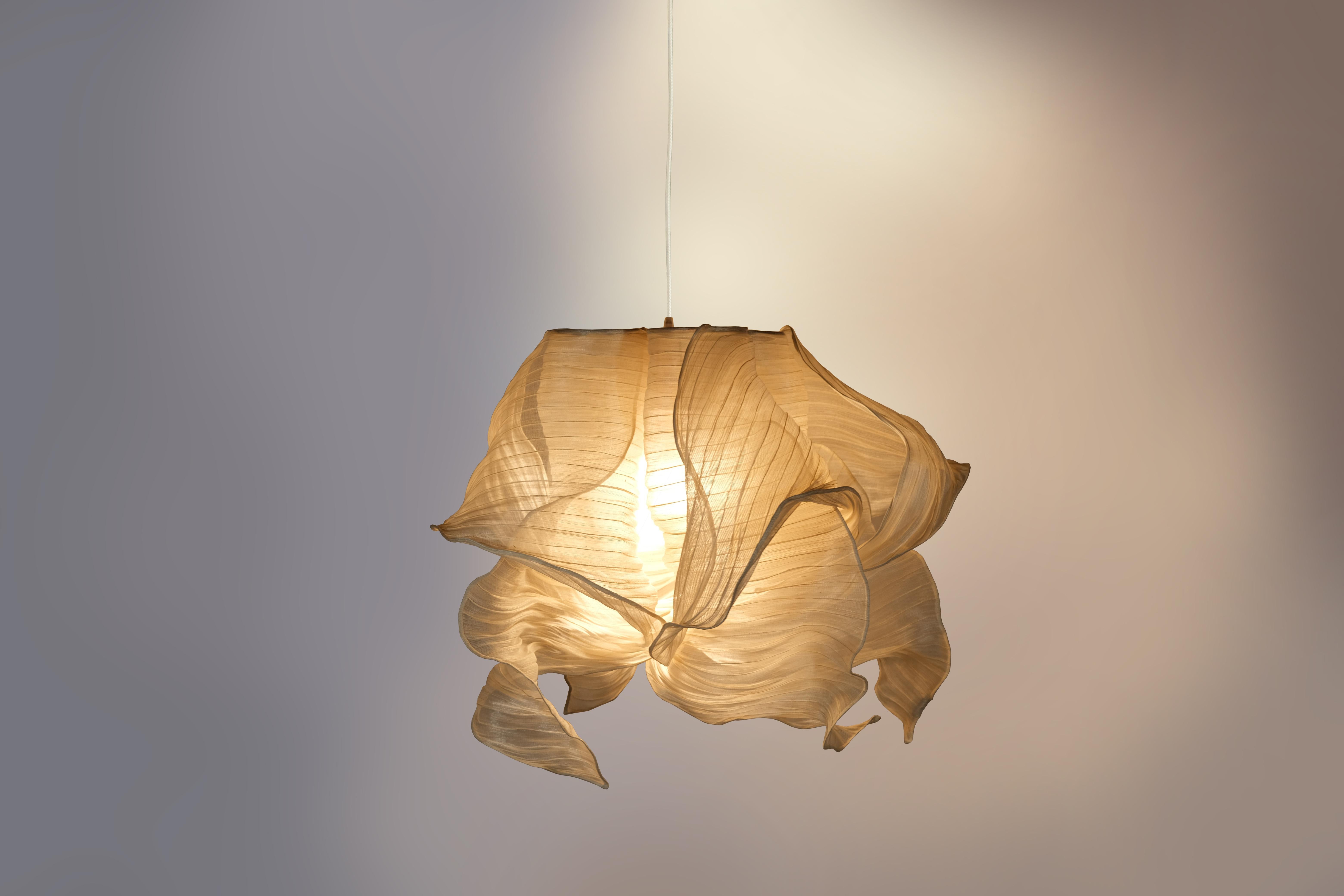 Cream Nebula pendant lamp by Mirei Monticelli
Dimensions: D 60 x W 60 x H 60 cm
Materials: Banaca fabric
Available in other colors.

Providing soft light in an organic and unique design, the Nebula Lamp draws its inspiration from the