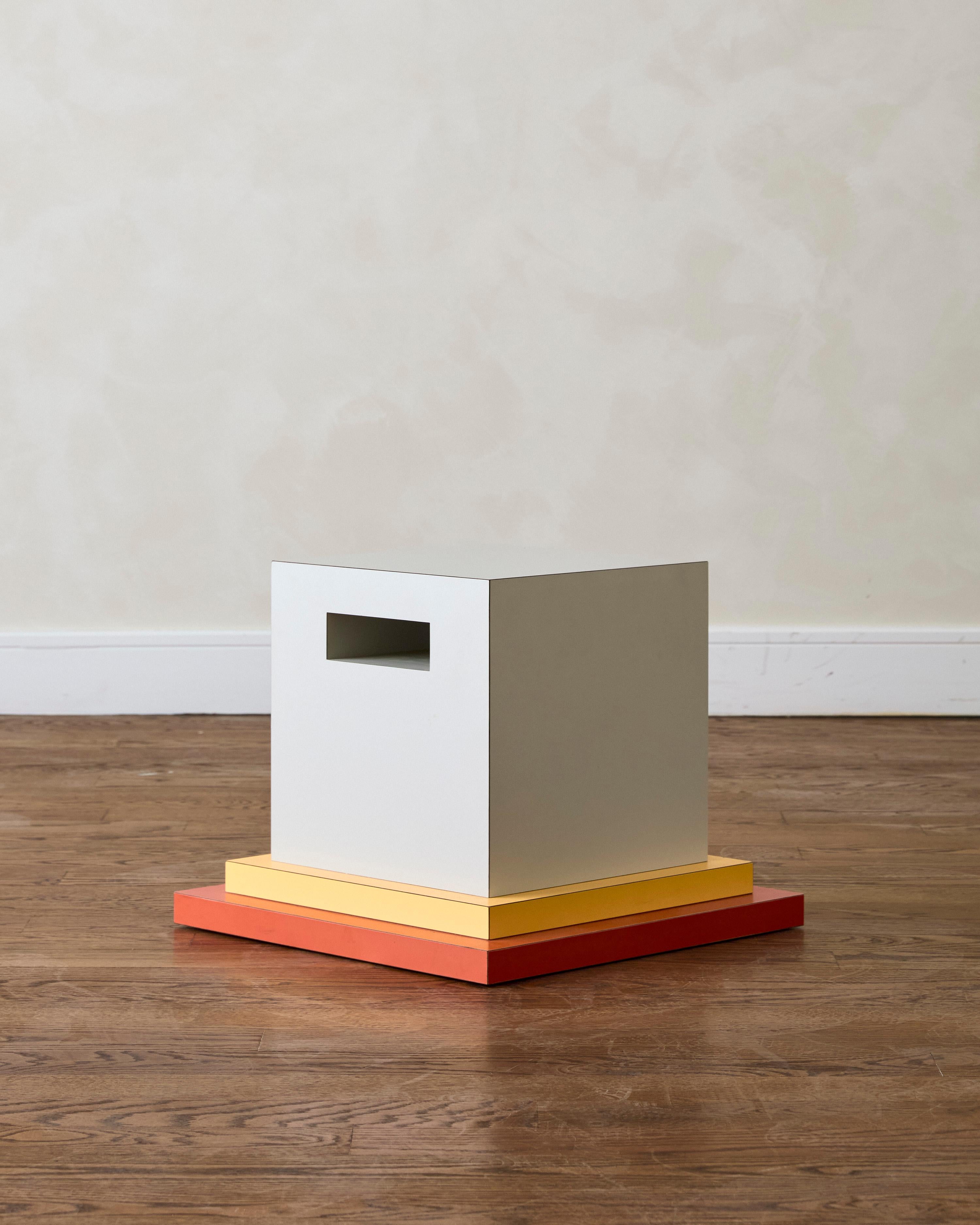 Memphis Occasional Table by Ettore Sottsass, crafted from stacked laminated wood and marked with an aluminum manufacturer's label on the side reading ‘Memphis Milano Ettore Sottsass’.