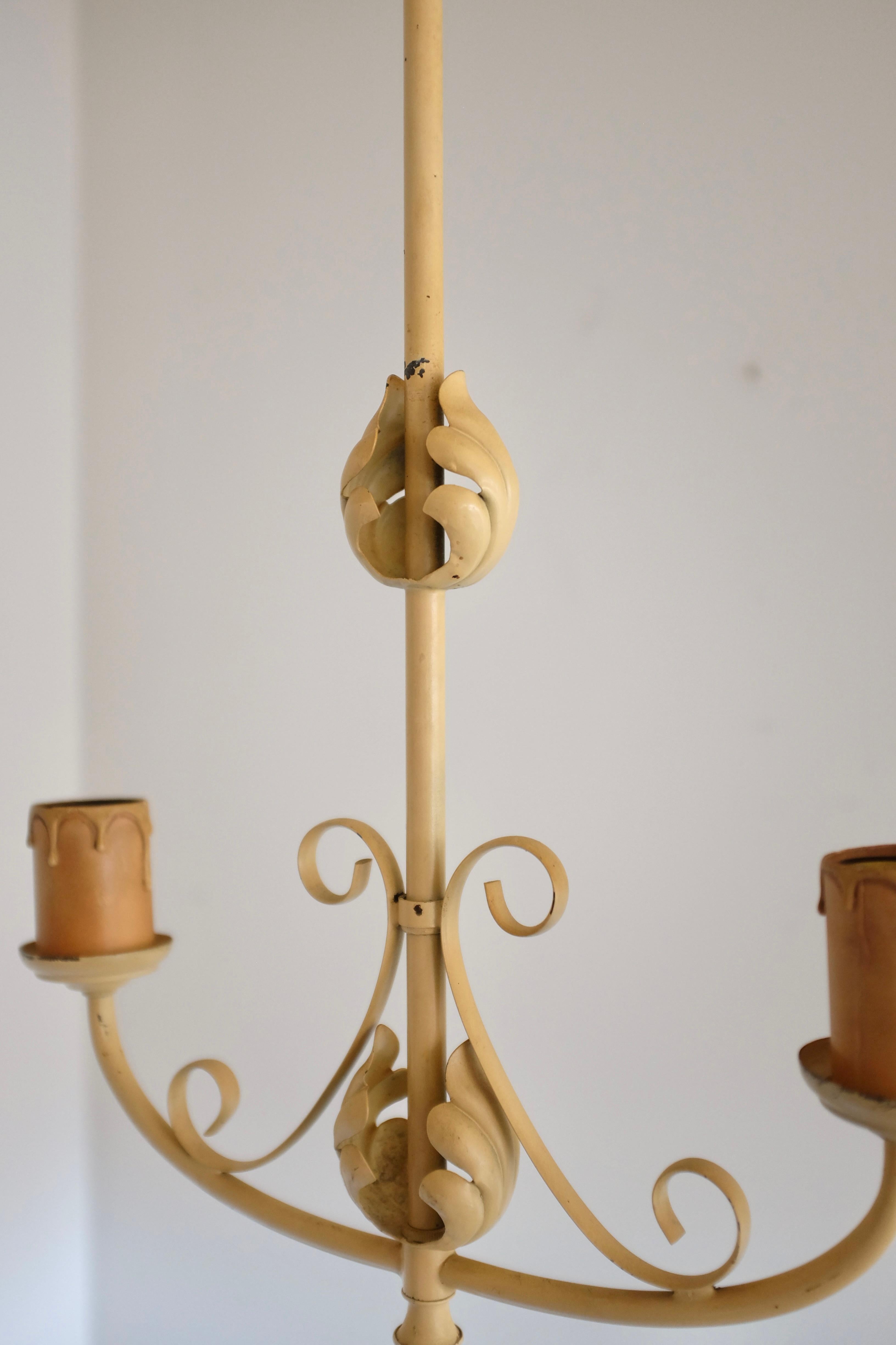 Pendentif suédois moderne des années 1950 en métal peint en crème avec des ornements de feuilles organiques. Deux sources lumineuses avec douilles imitation bougie (l'imitation bougie est posée en vrac et peut être retirée). Le câblage est d'origine