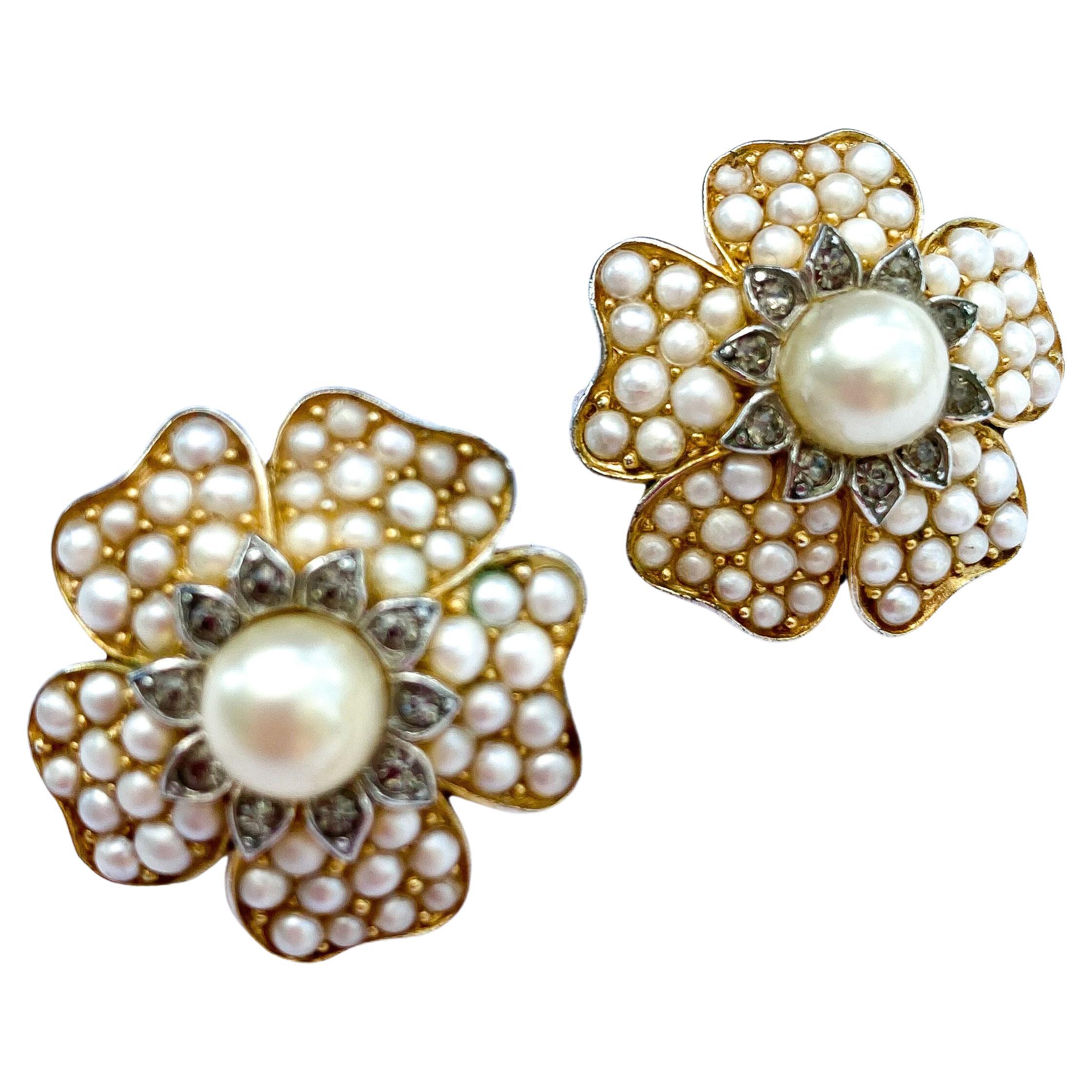 A beautiful pair of 'flower' or 'camellia' earrings made by Trifari, in the 1960s, with a subtle and chic combination of tones. Unusual grey coloured pastes sit side by side with cream paste pearls, all small. giving a finesse and wearablity to