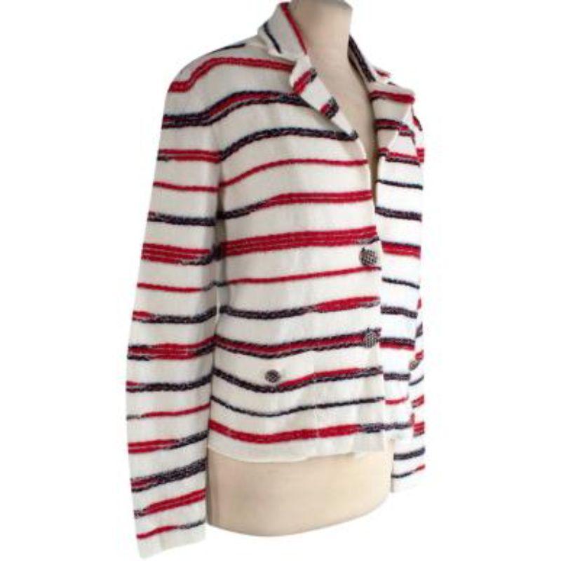 Chanel cream & red knitted cashmere jacket
 
 
 
 - Soft handle, midweight cashmere knit adorned with boucle stripes
 
 -Two-button fastening 
 
 -Two faux pockets at the waist 
 
 -Classic collar 
 
 - Unlined 
 
 
 
 Material: 
 
 97% Cashmere 
 
