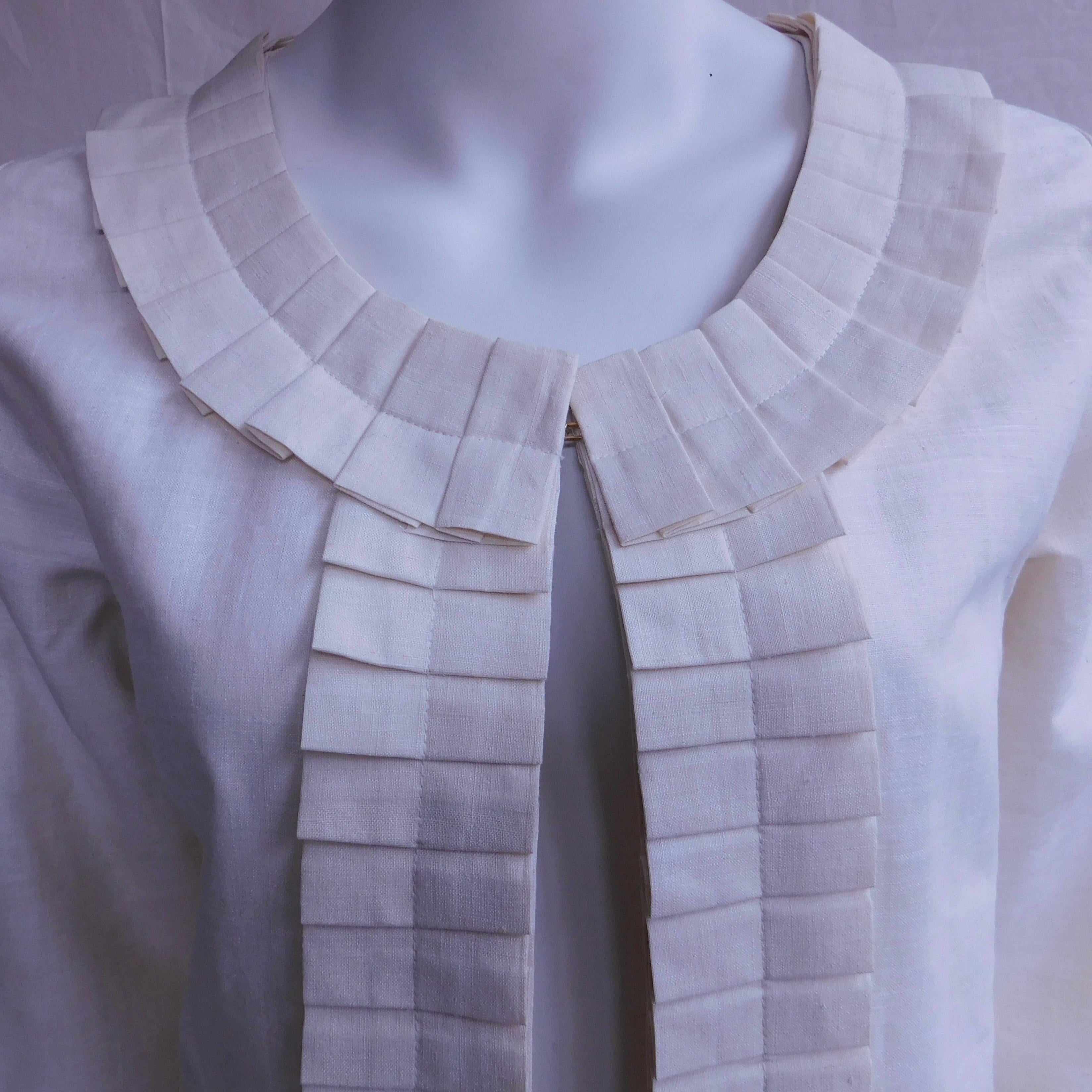 A Cream silk jacket made in Madrid Spain by Anauve. Hand pleated details and tailoring perfect the minimalist feminine chic look . Completely lined in silk with hidden hook closures.
shoulder width=37 cm 
fits a small to medium