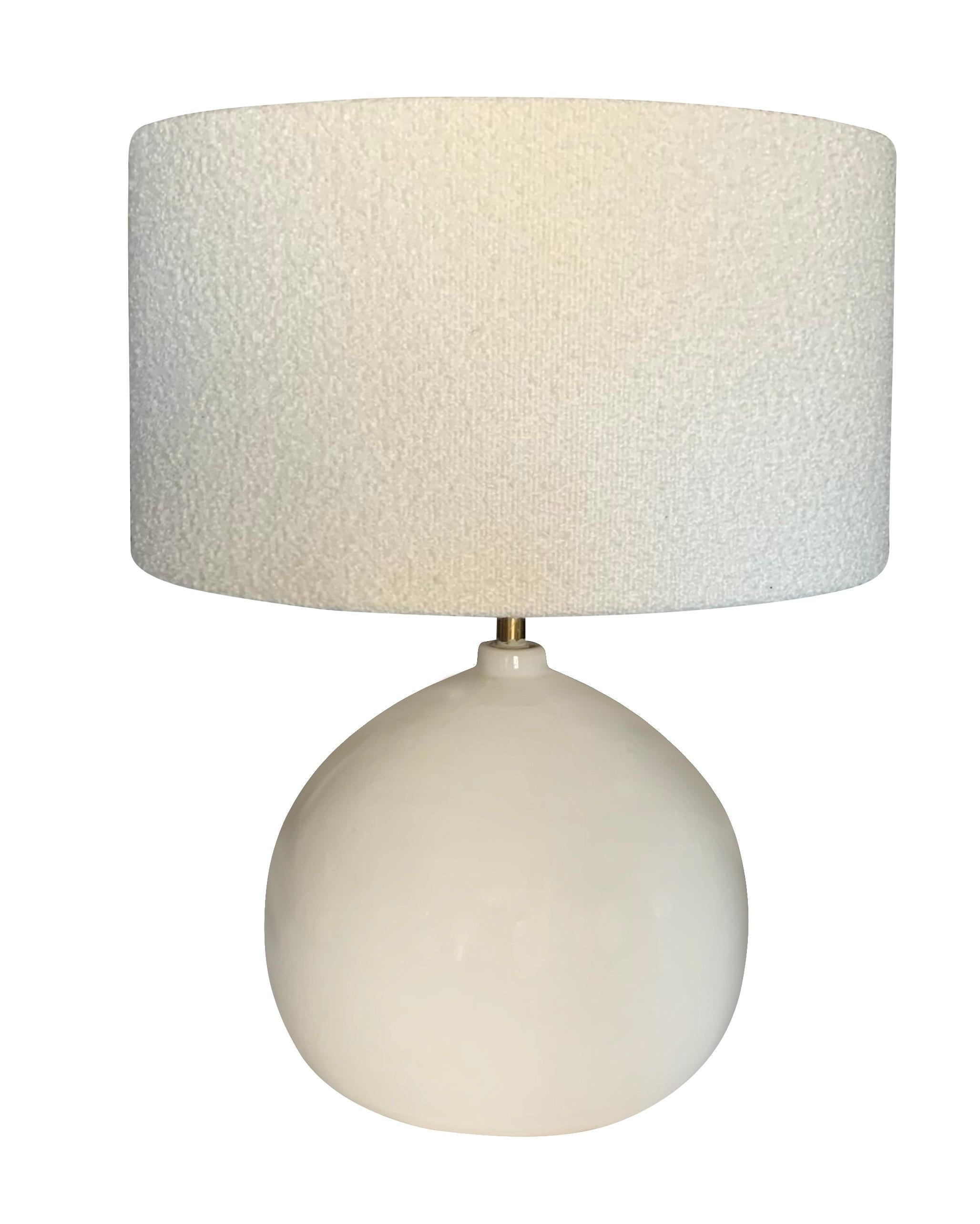 Contemporary Chinese pair cream colored small spout opening lamps.
Round shaped base.
White boucle shades included.
Base diameter measures 10