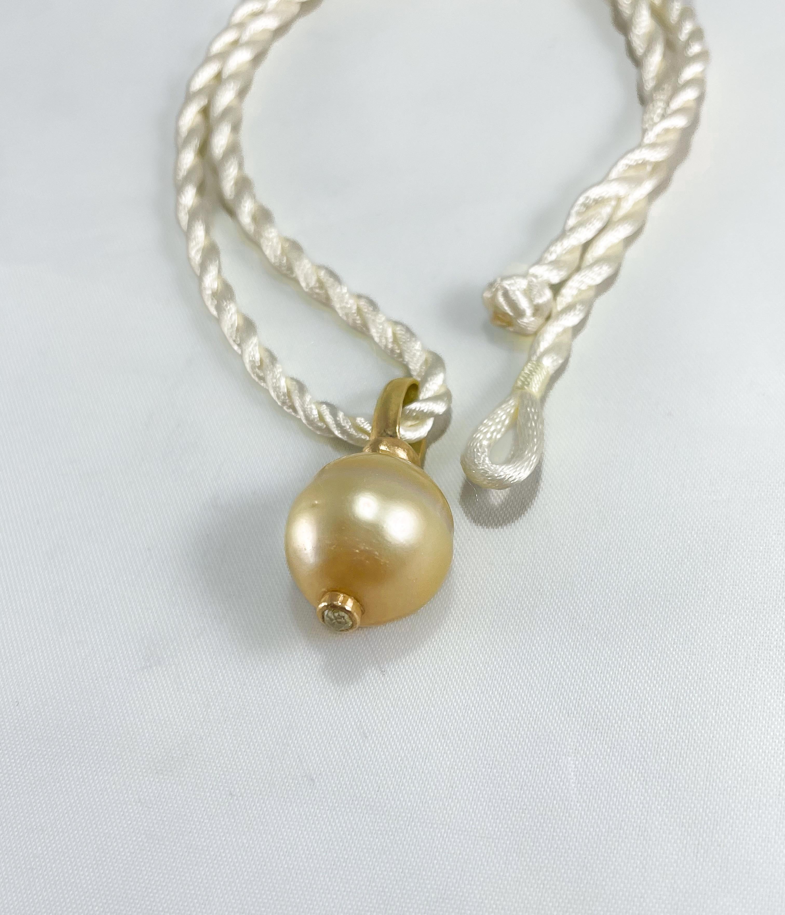 Cream cultured pearl choker pendant. Hand crafted. Large 17mm cultured cream pearl. It is a stunner on a long 18K gold bail on one side and punctuated by a rose cut yellow diamond on the other.  

The pearl pendant will arrive with silk cord as in
