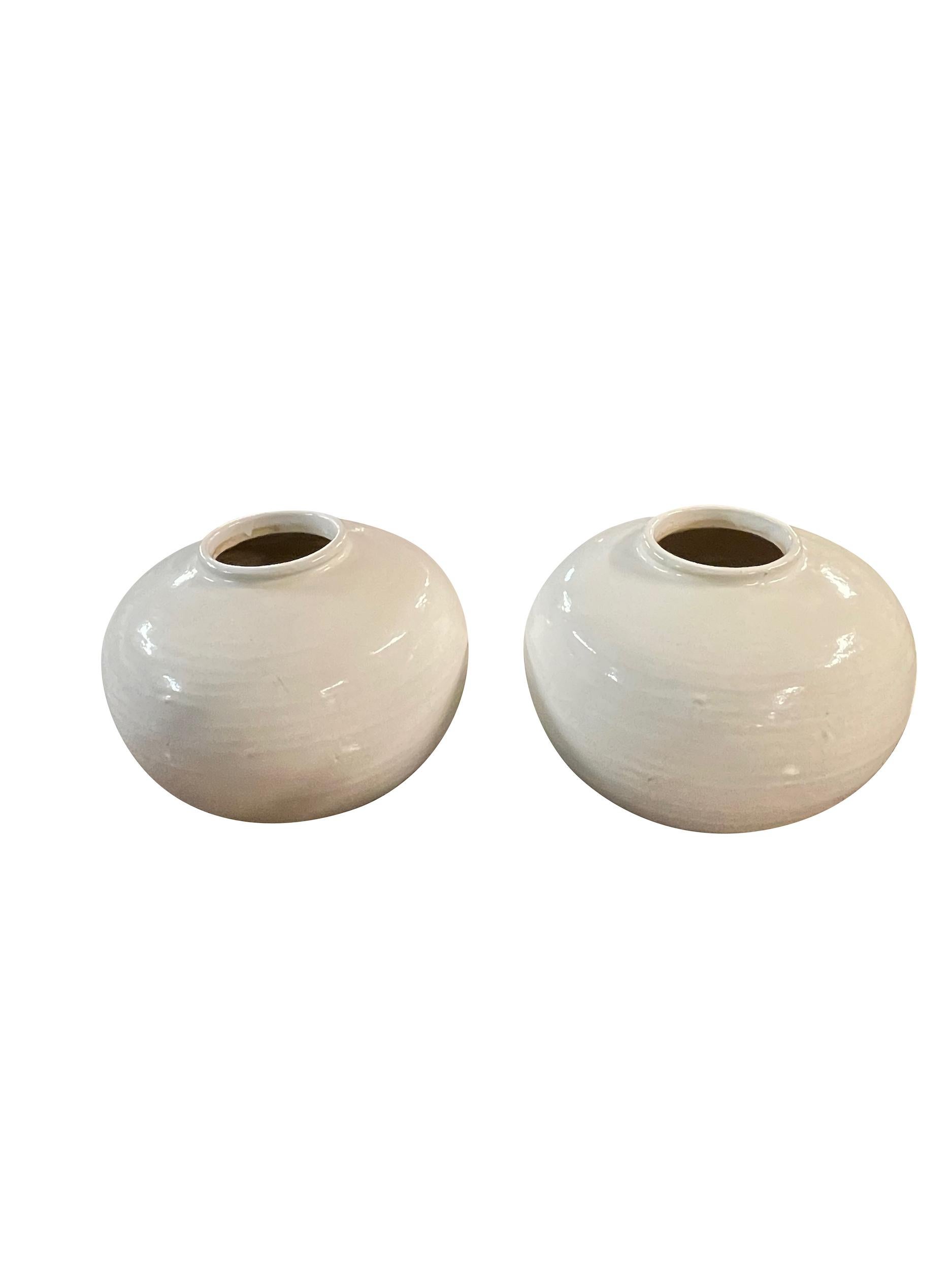 Contemporary Chinese large squat shaped cream vase.
Two available and sold individually.
From a large collection of cream colored vases.