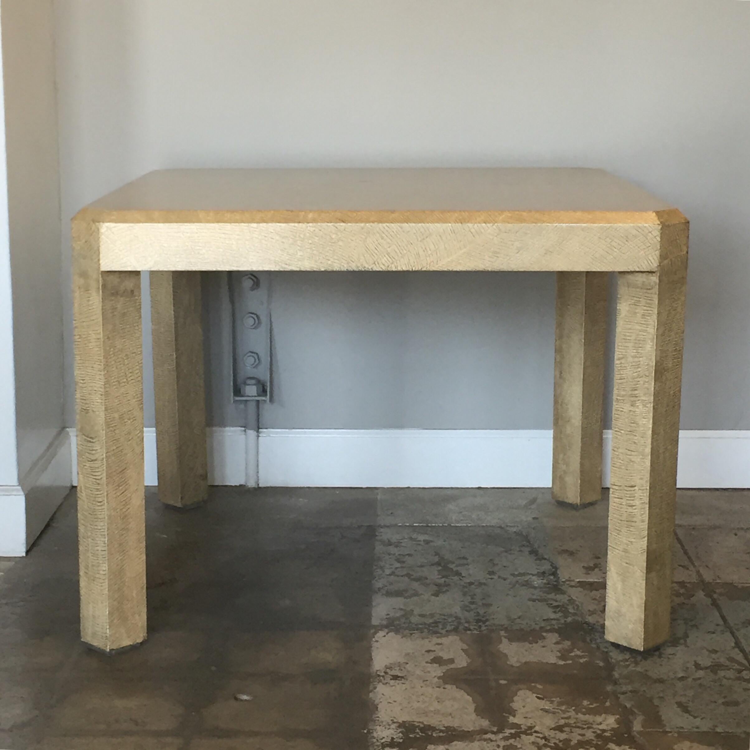 Cream textured parchment clad game table by Karl Springer. Lucite sabots.