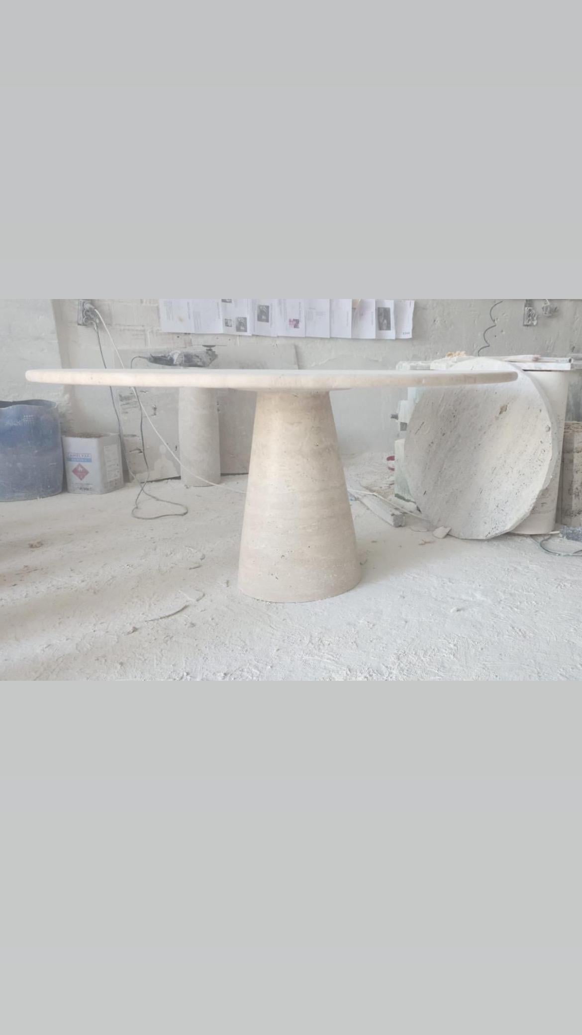 This minimalist table is made from solid tumbled travertine, featuring a circular table top that balances perfectly and securely with its own weight. 

Drawing inspiration from the vintage pieces of Angelo Mangiarotti, the column leg gives this