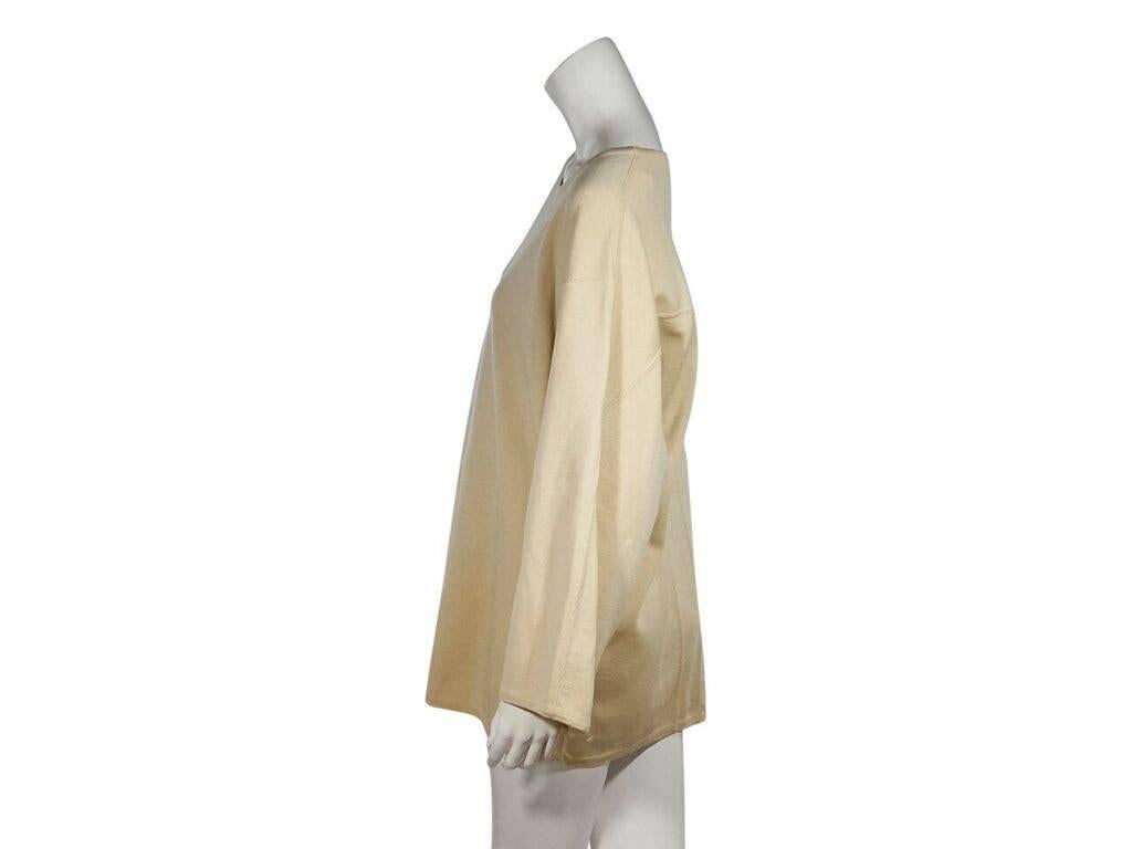 Product details:  Vintage cream oversized wool sweater by Alaia.  Boatneck.  Long sleeves.  Pullover style.  48