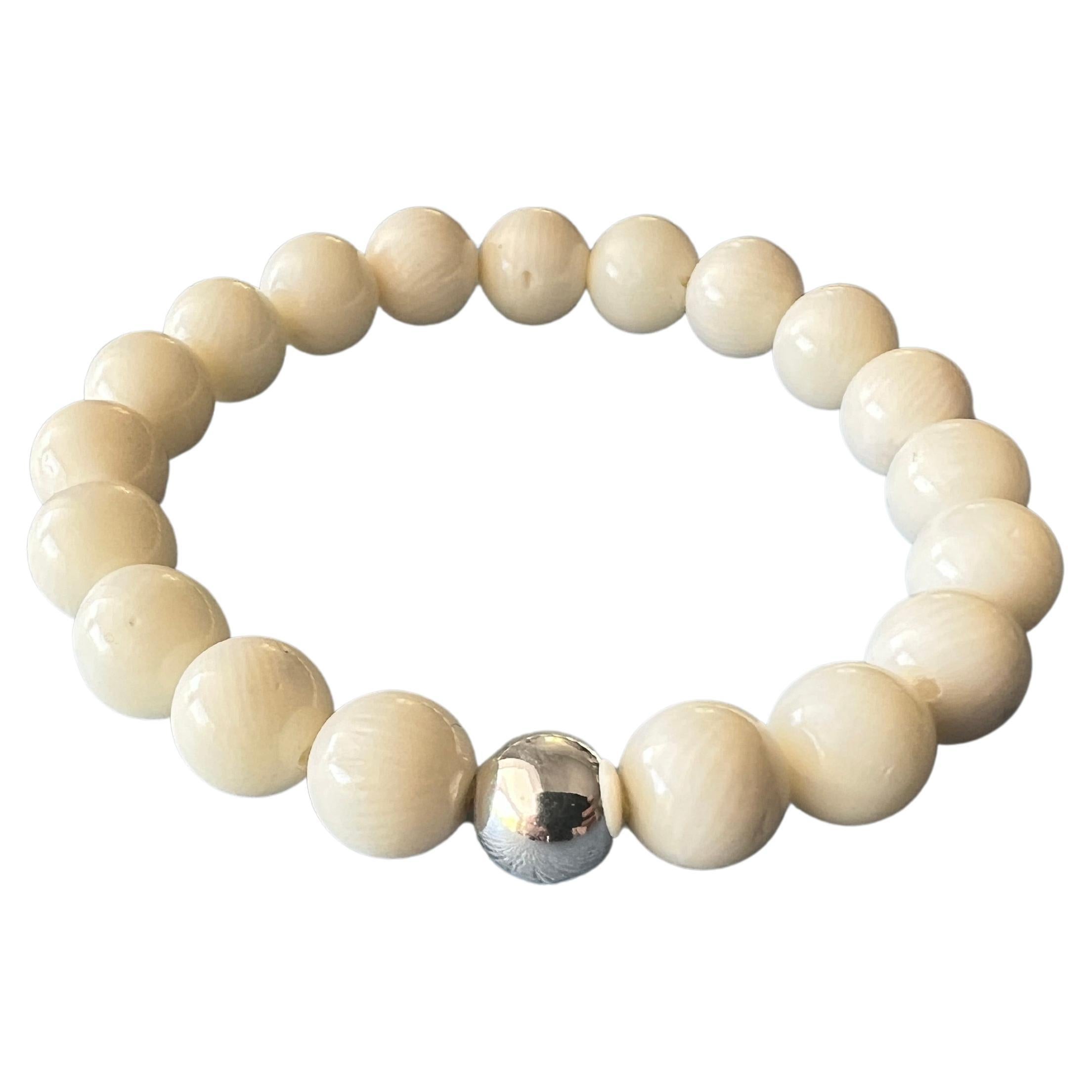 Cream White Bamboo Round Bead Bracelet Elastic Bracelet with Silver Bead 

Made in Los Angeles

Designer: J Dauphin

The Cream White Bamboo Round Bead Elastic Bracelet with Silver Bead offers a unique blend of natural beauty and metaphysical